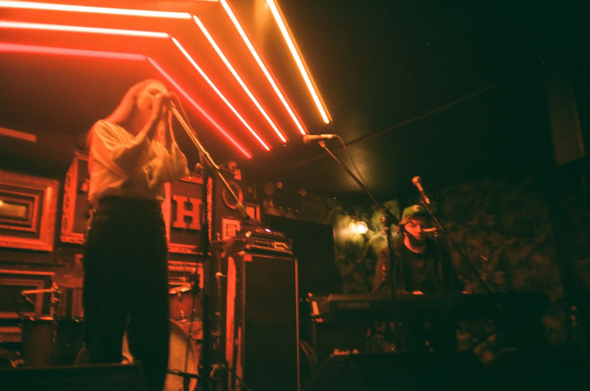 Live band performance on stage with red neon lights. TurboHaus Montreal