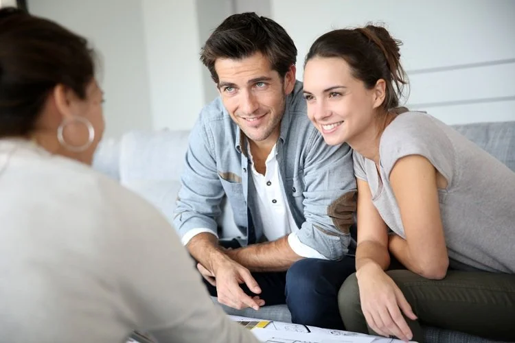 Young couple look to an advisor