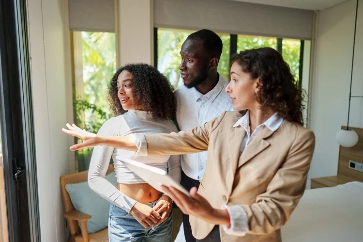 Prospective buyers tour house with real estate agent