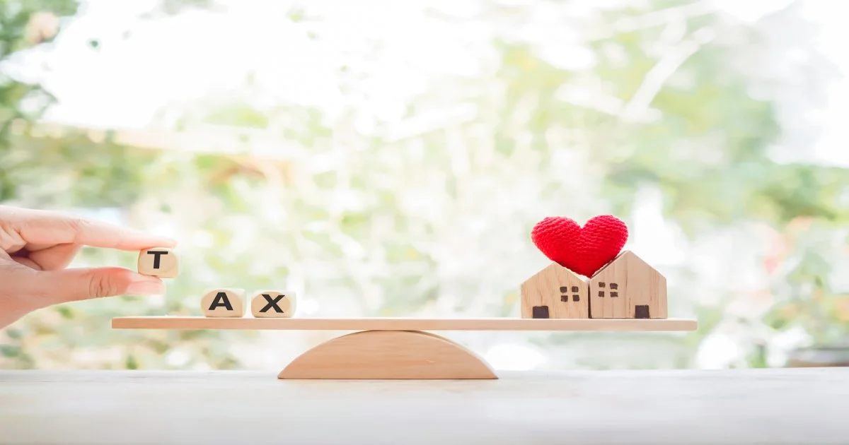close-up-hand-holding-wooden-block-with-word-tax