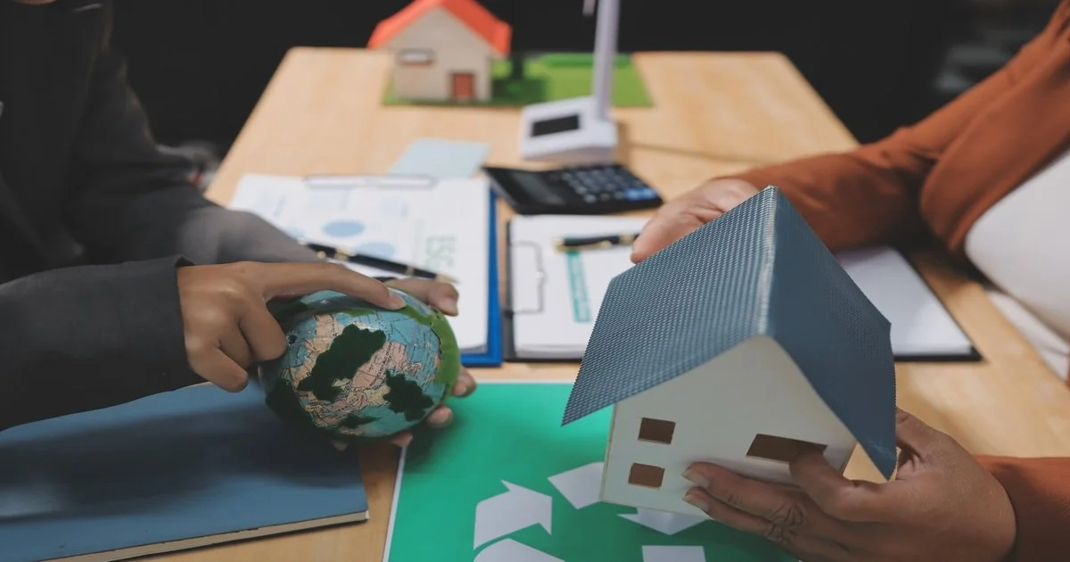 two-people-are-holding-a-paper-house-and-a-globe-talking-about-homeownership-education-workshop