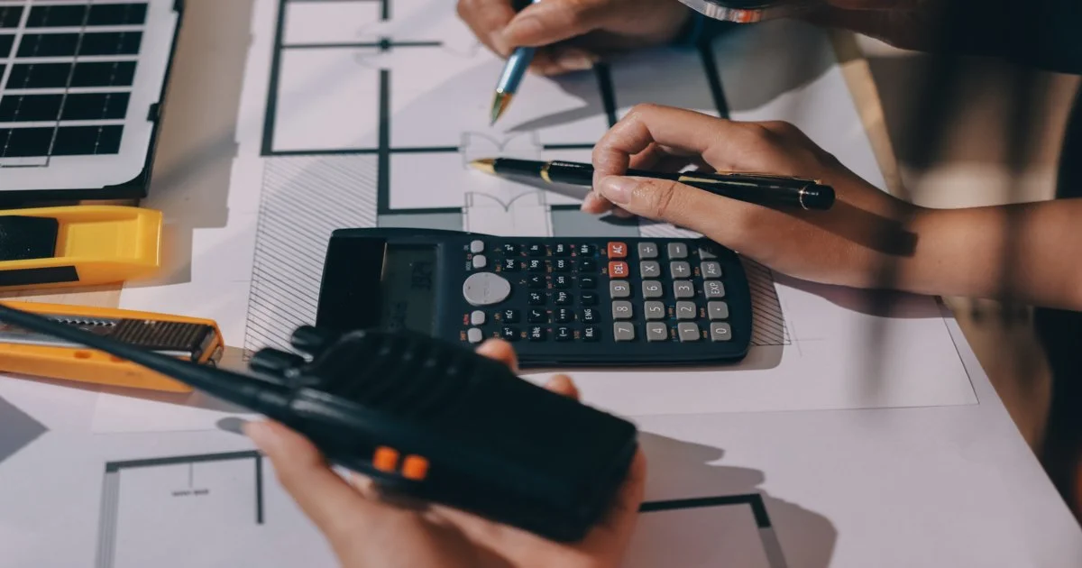 hands-working-on-a-calculator-and-other-tools-as-value-engineering