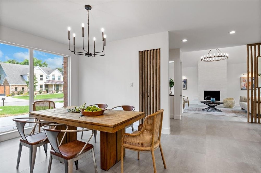 Dining area with a wooden table and views into an open living room