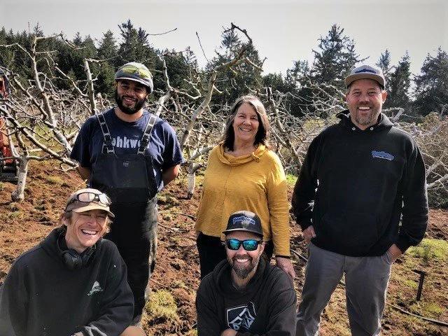 Mary Keehn and crew plant apple trees at the We Are Up property