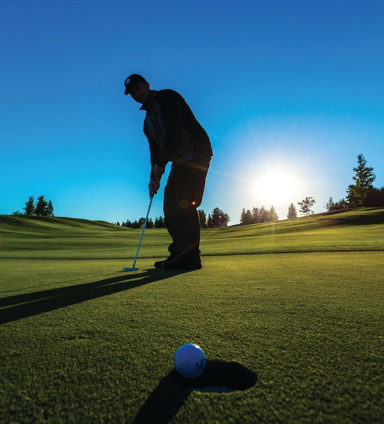 Generic golfer dropping a putt.vertical.jpeg