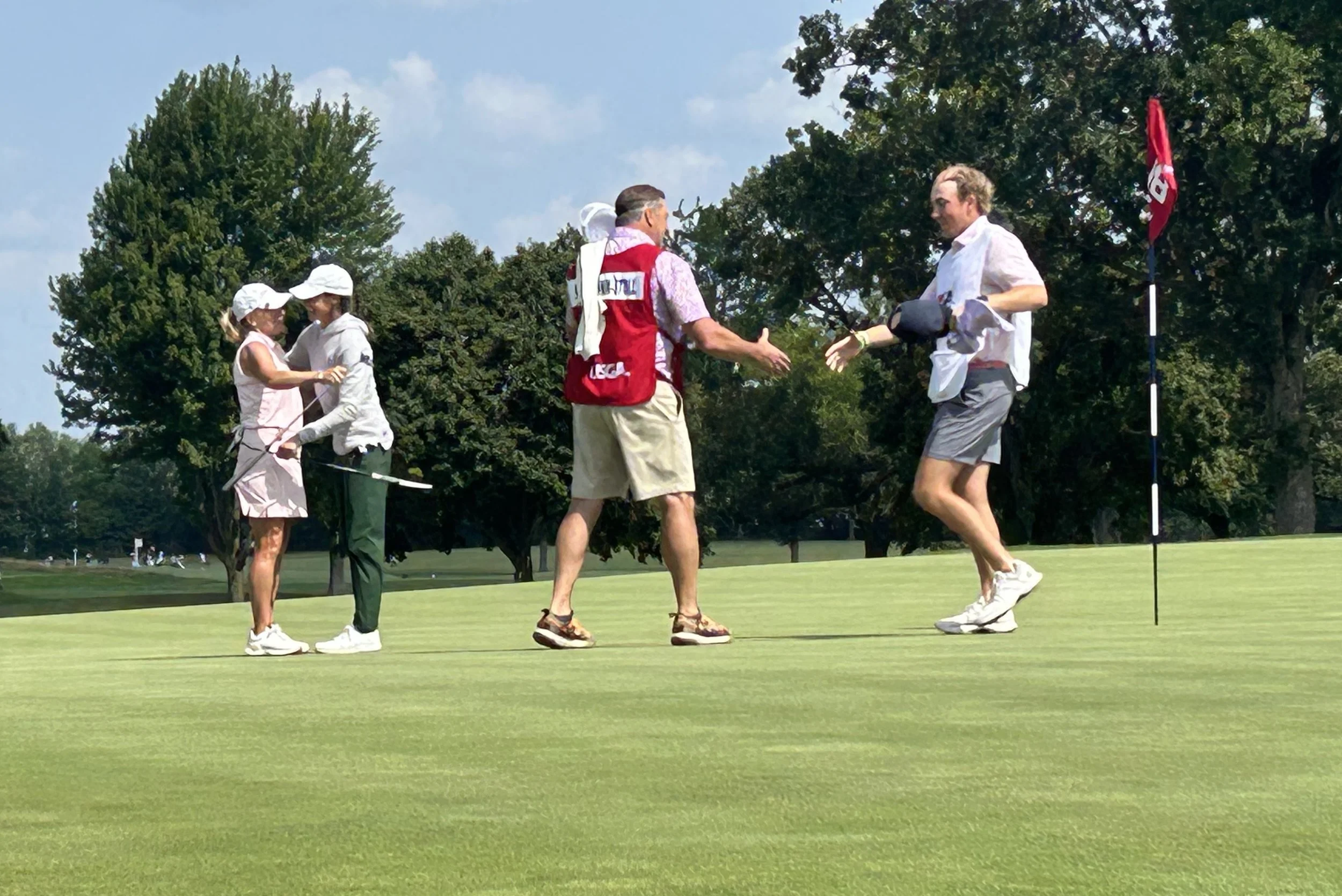 Suzy and Stacy hugs on 18 green.jpg
