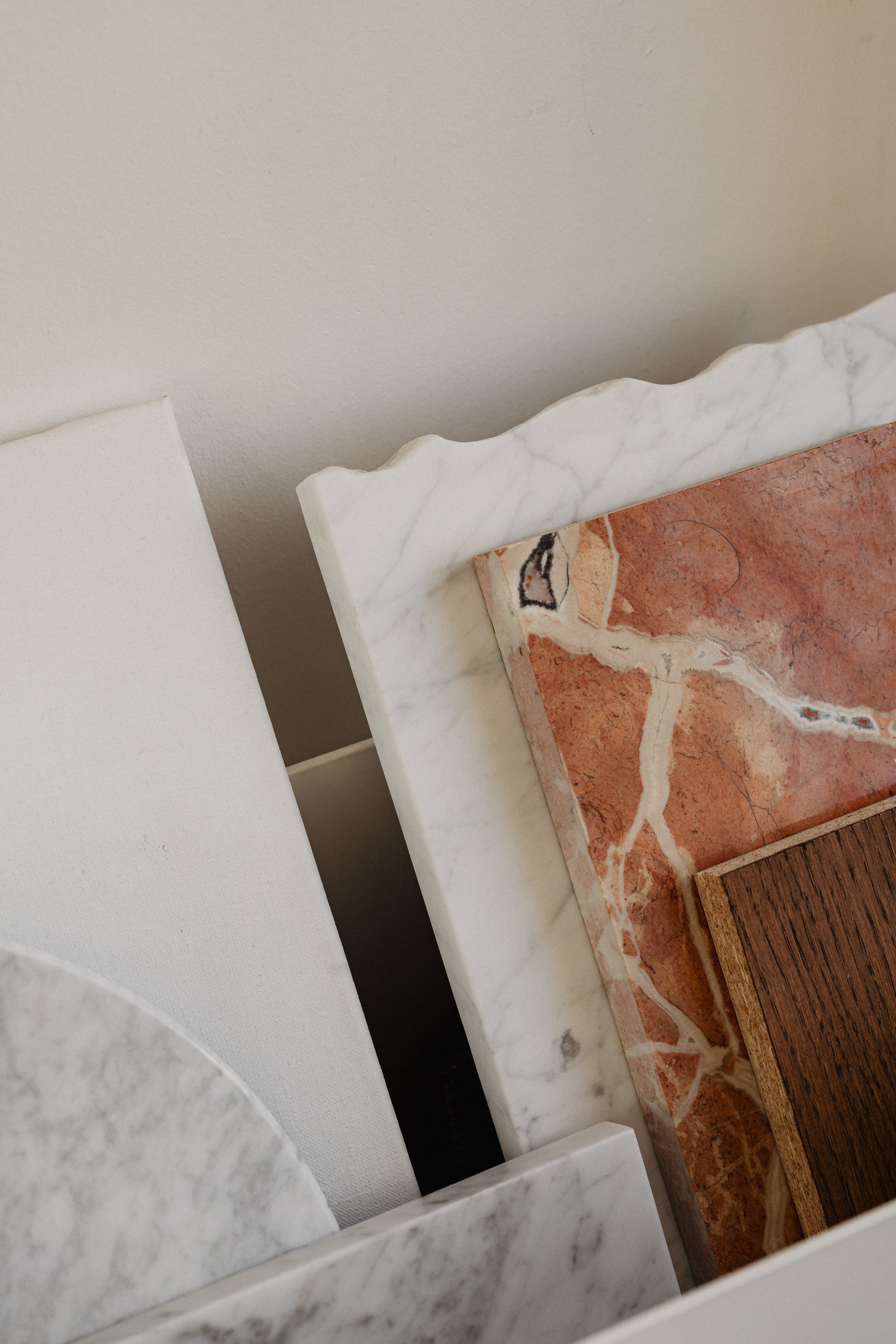 Close-up of layered marble and wooden tabletops with different textures and colors.