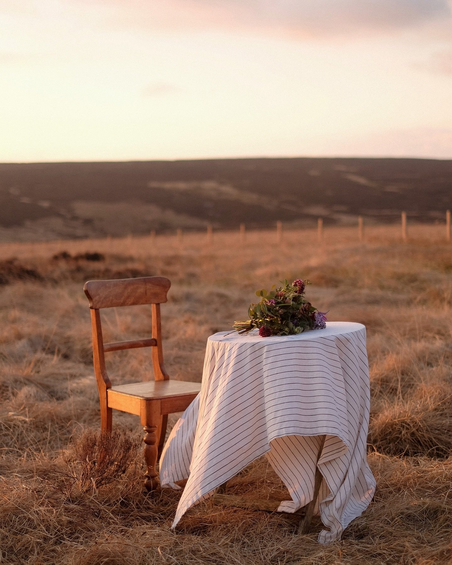 The perfect spot for a golden hour glass of wine, up on the moors. From a fun shoot with @our.kindred a couple of years ago, prancing around on the muddy moors with linen tablecloths, bouquets of flowers and floaty dresses.

#springintospring #spring