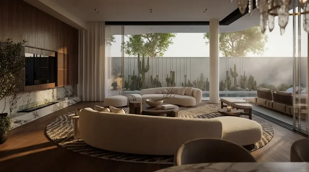 Modern living room with large glass windows, cactus plants outside, and contemporary furniture including a curved sofa, armchairs, a coffee table, and a rug.