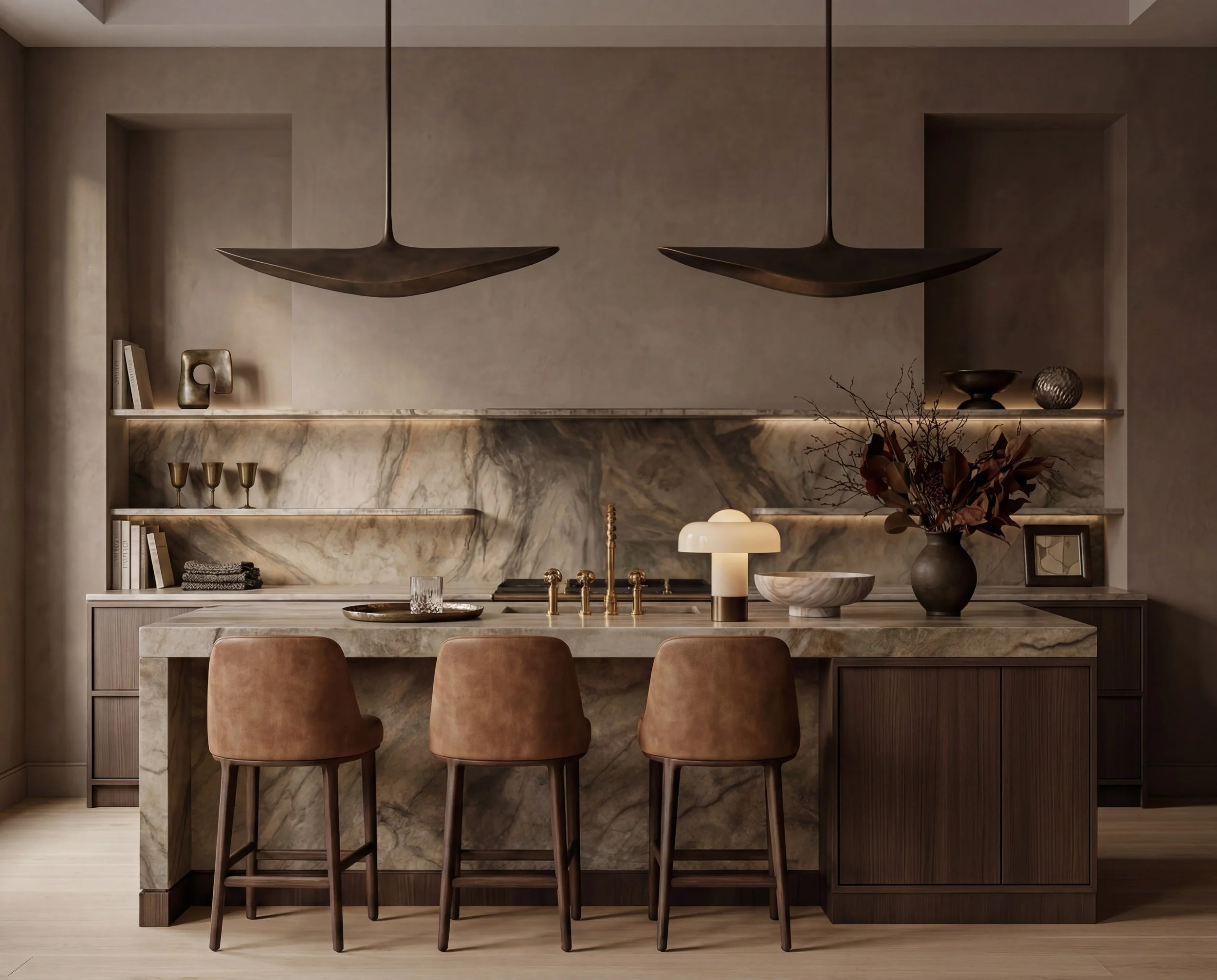 Modern kitchen with marble island, three brown barstools, decorative vases, and minimalist shelving with art and plates.