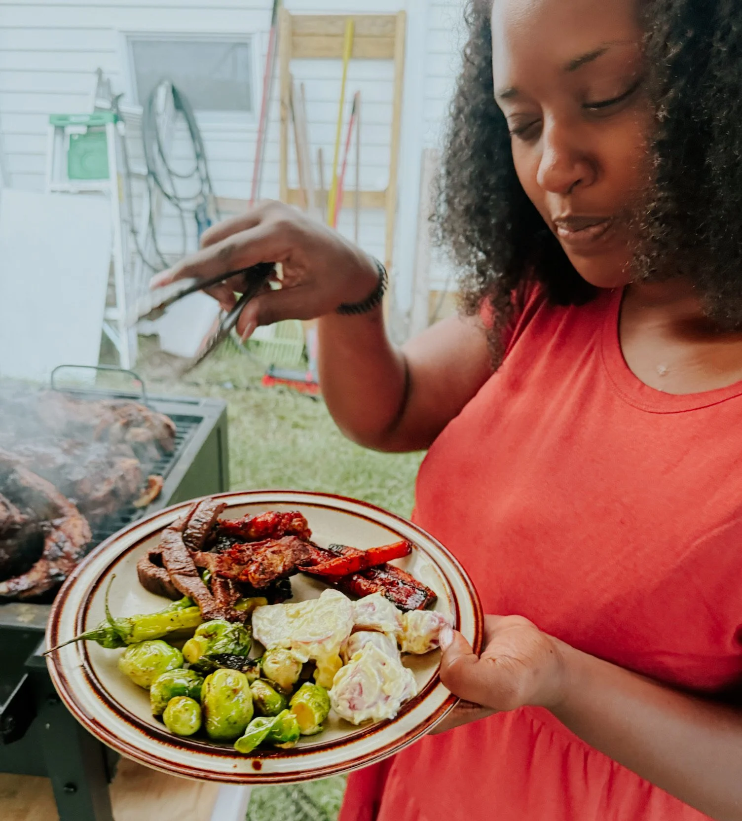 Rose adding wings to her full plate at Summer Grillin.JPG