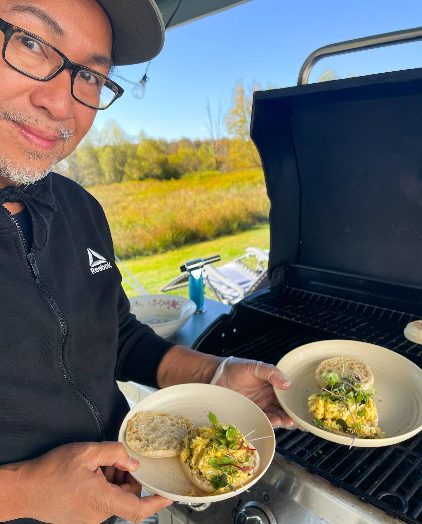 Allan serving Saturday BReakfast Thyme Butter Scrambled Eggs on English Muffins Autumn GLow Catskills Camping Weekend at Basecamp Brooklyn Estates.JPG