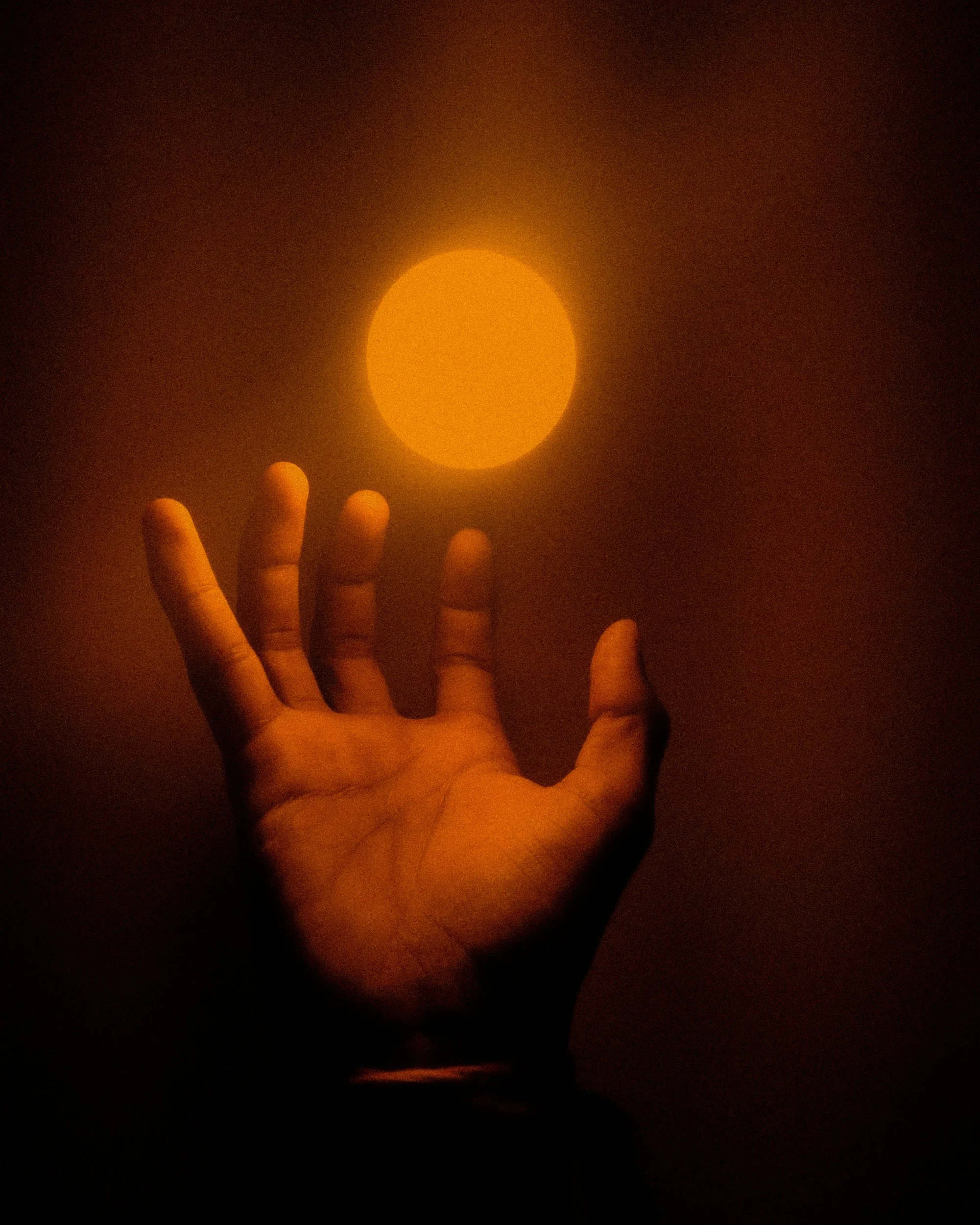 Person practicing energy healing with glowing hands