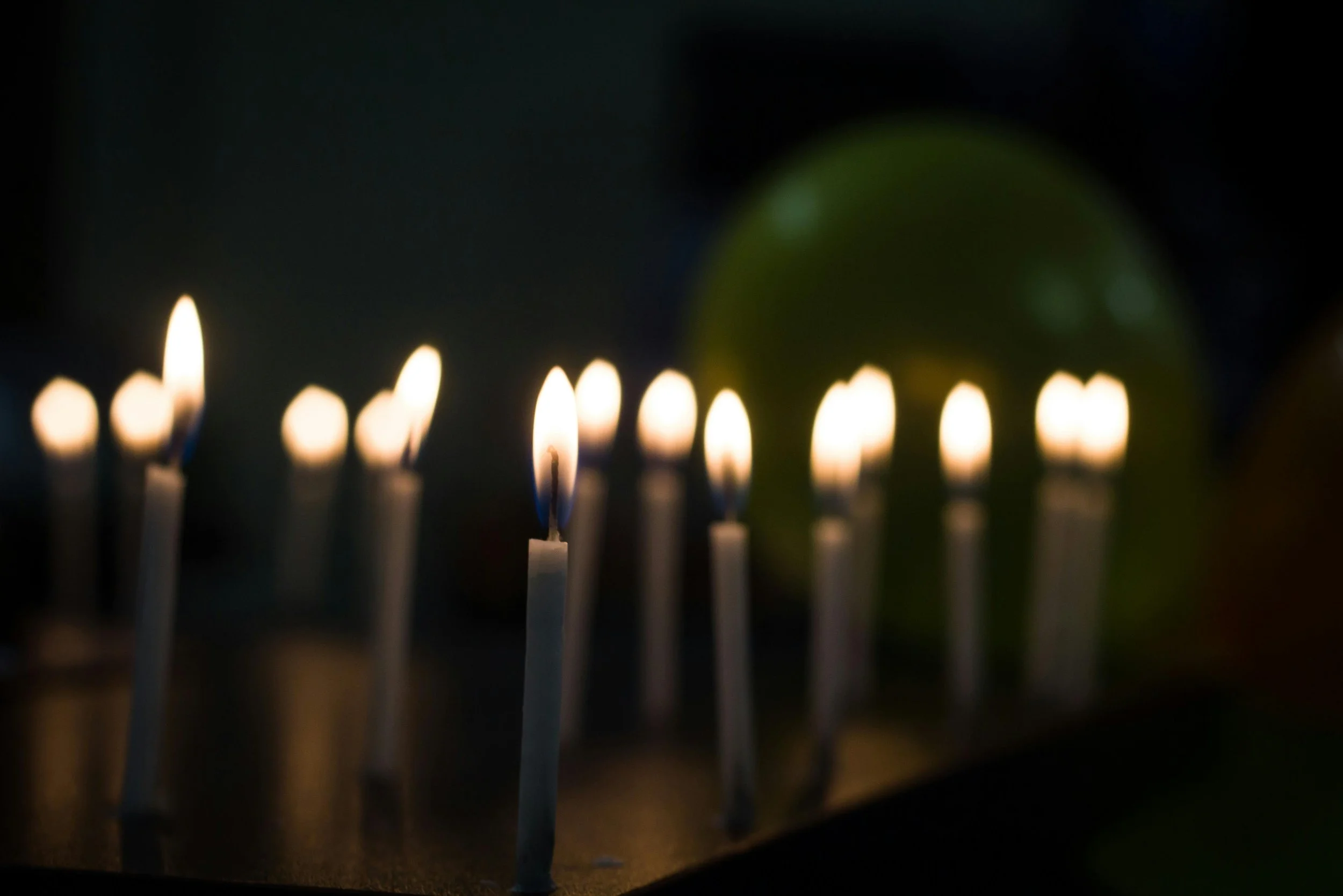 Softly glowing candles set up as a memorial, creating a comforting atmosphere for a Pet Loss Support session.