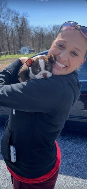 Brandi Van smiling and connecting with her dog, demonstrating the bond between humans and pets through communication and intuitive guidance.