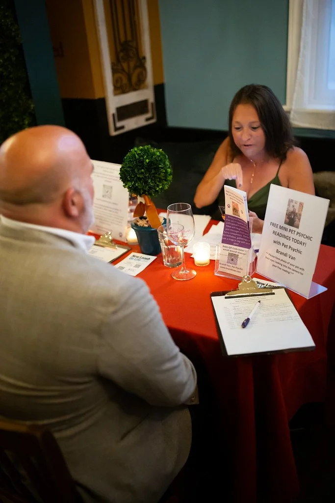 Pet communicator Brandi Van providing an in-person pet psychic reading at a local event.