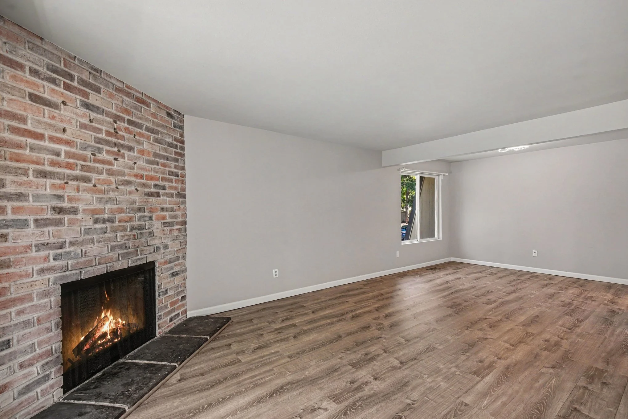 Living room with cozy fireplace looking towards dining area