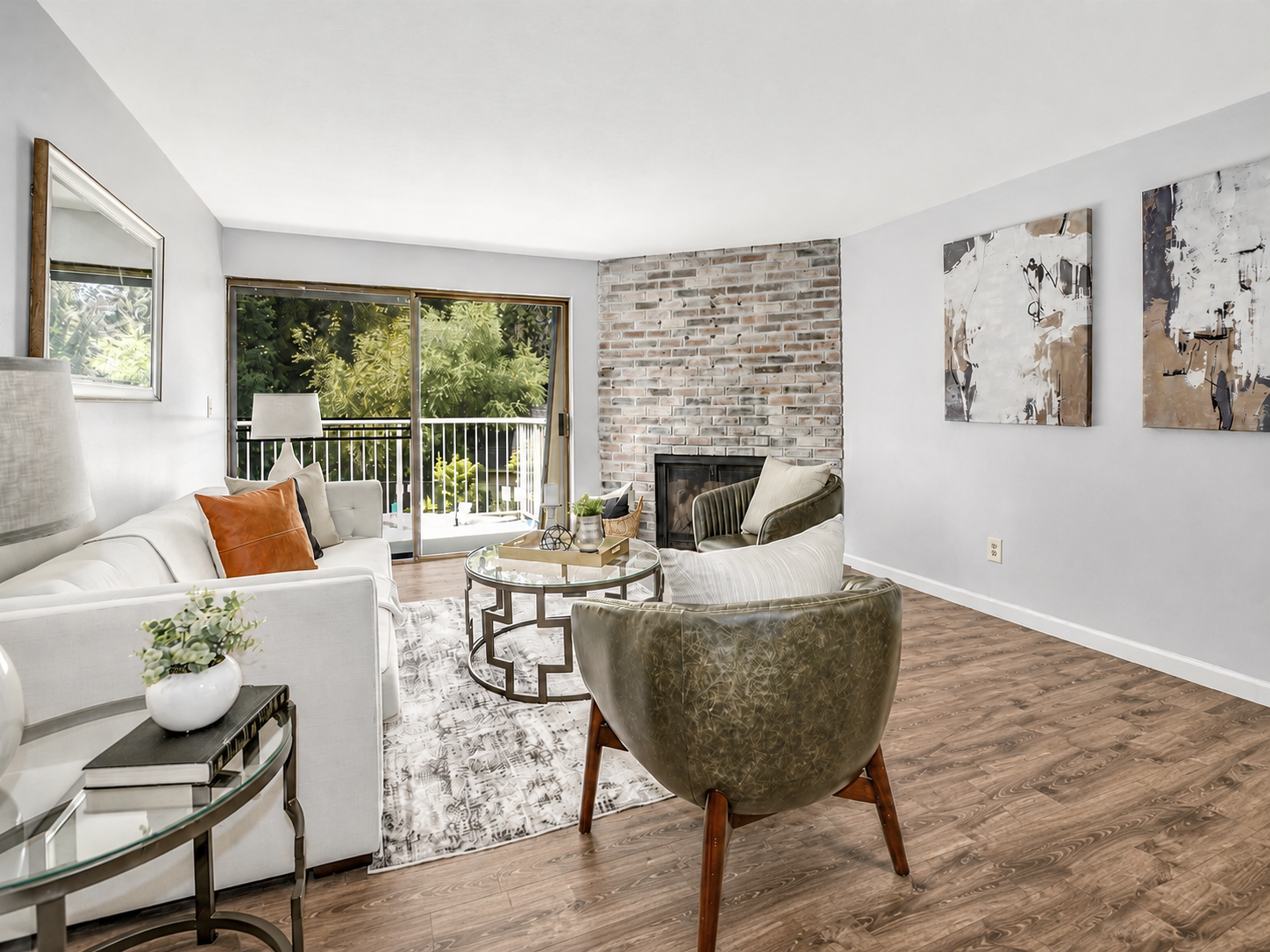Living room with slider to back balcony virtually staged with an alternative option including the couch on the left 