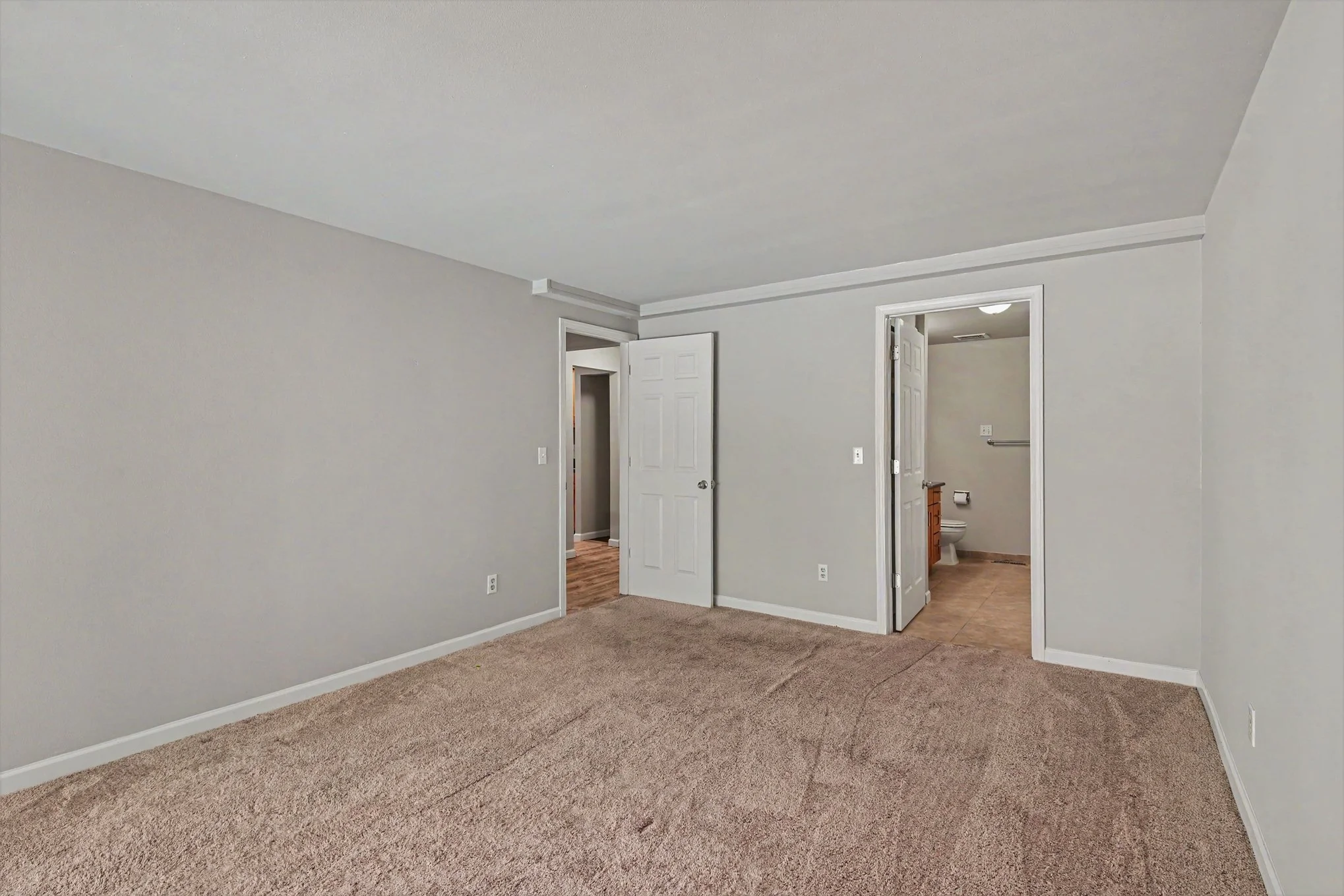 Primary bedroom with view to primary bathroom