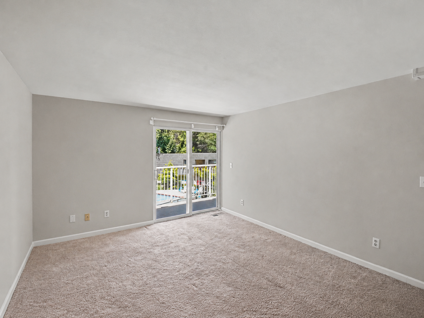 Primary bedroom with slider to back balcony view 2