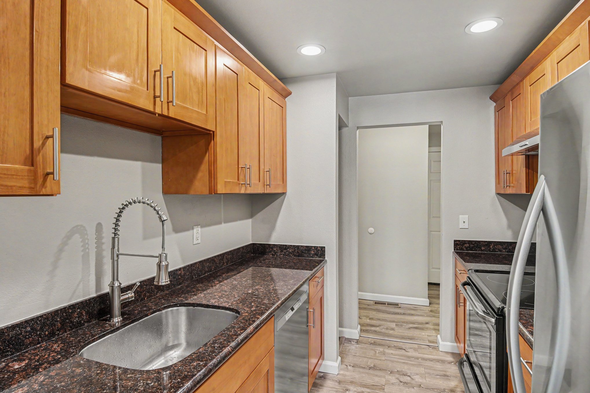 Beautiful kitchen with stainless steel appliances and sleek counters view 3