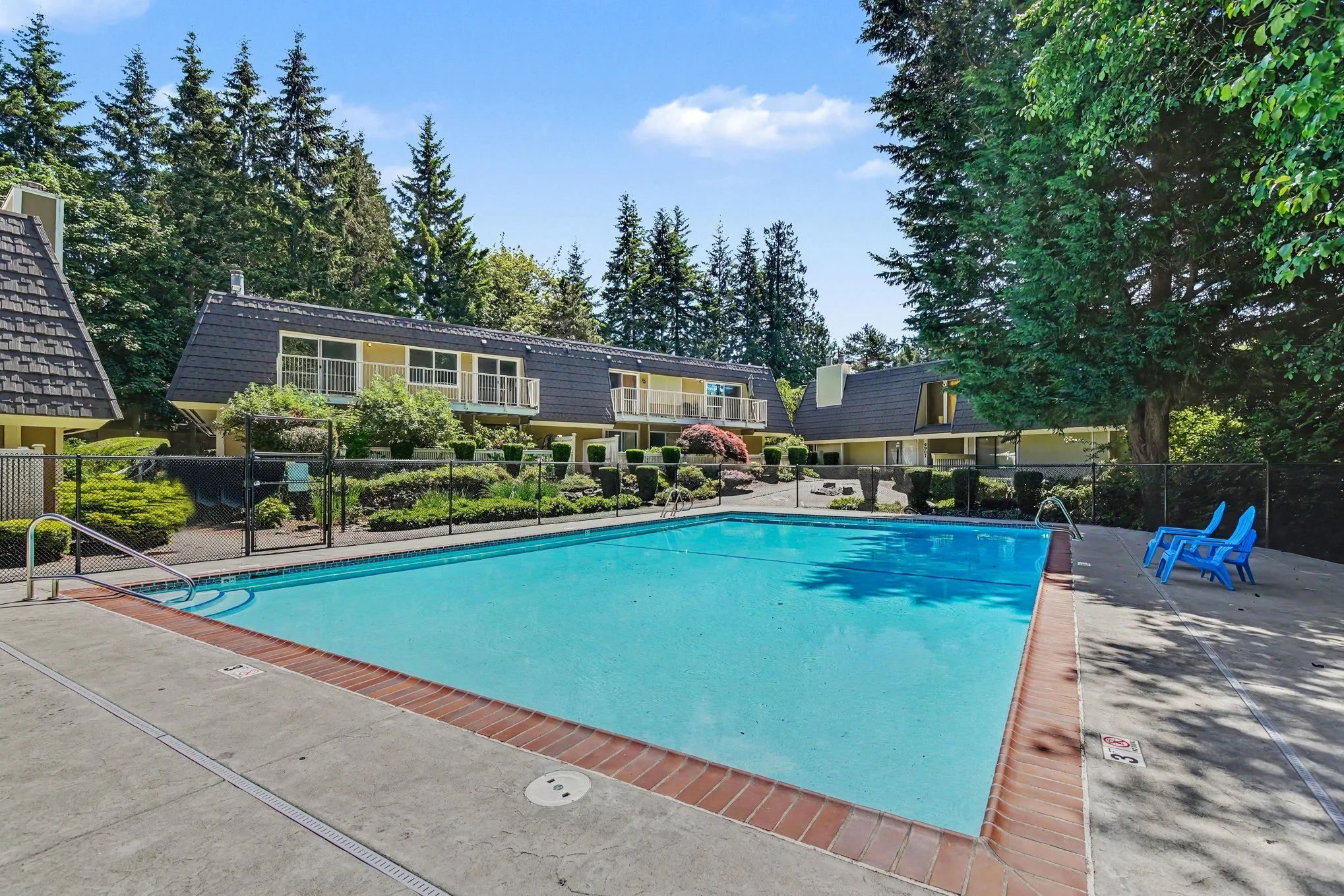 Back of condo, fully fenced pool area and outdoor lounge area