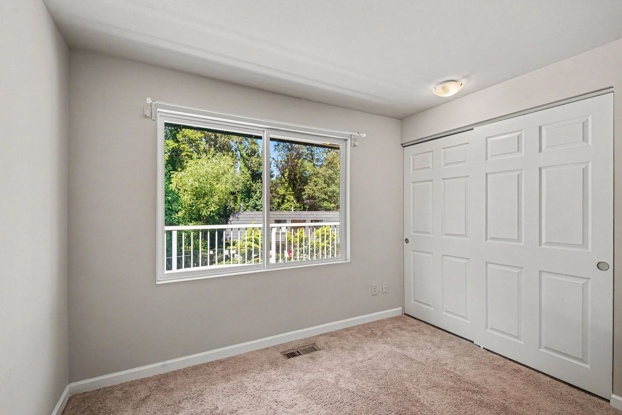 Bedroom 2 with view of pool and greenbelt