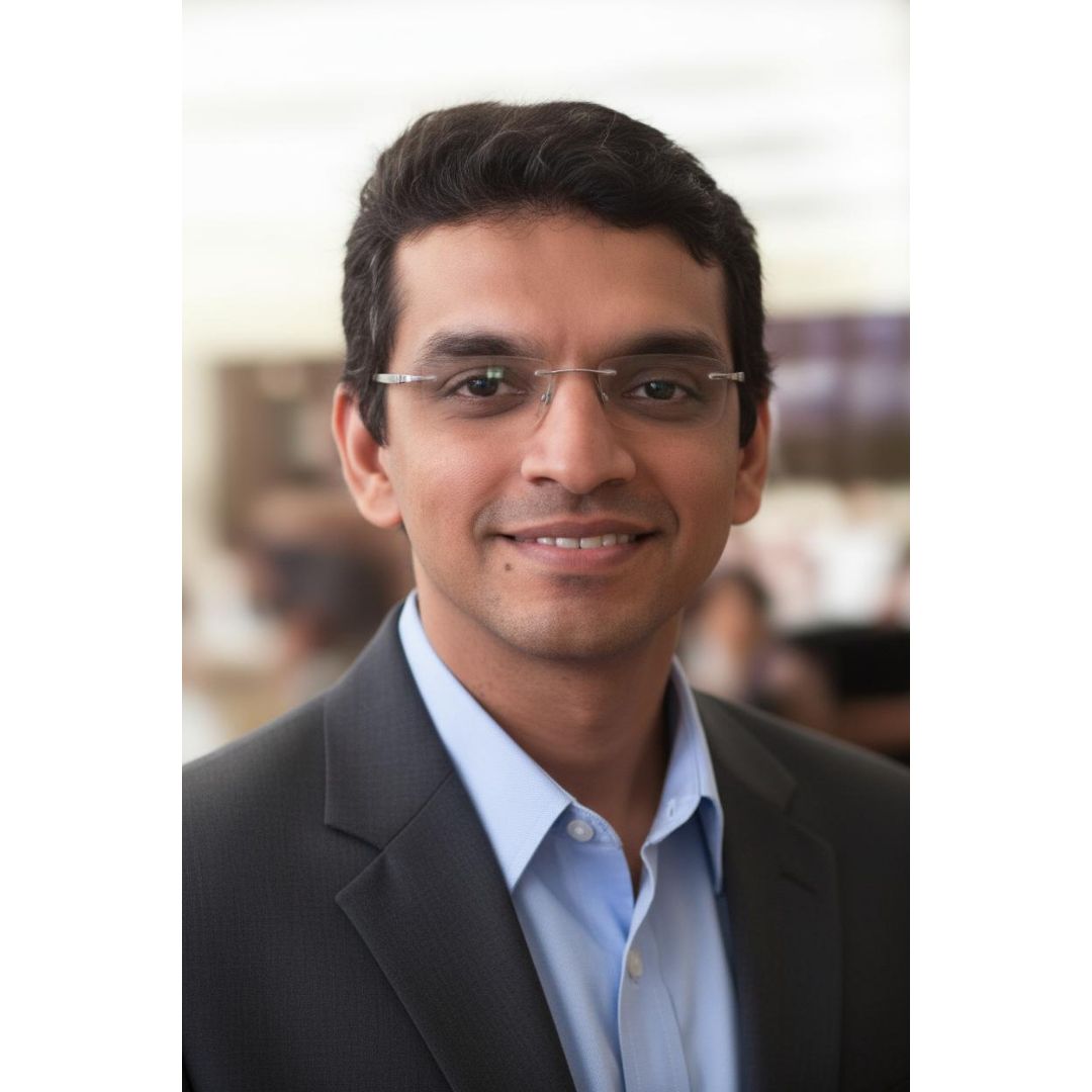 Smiling person wearing glasses and a suit