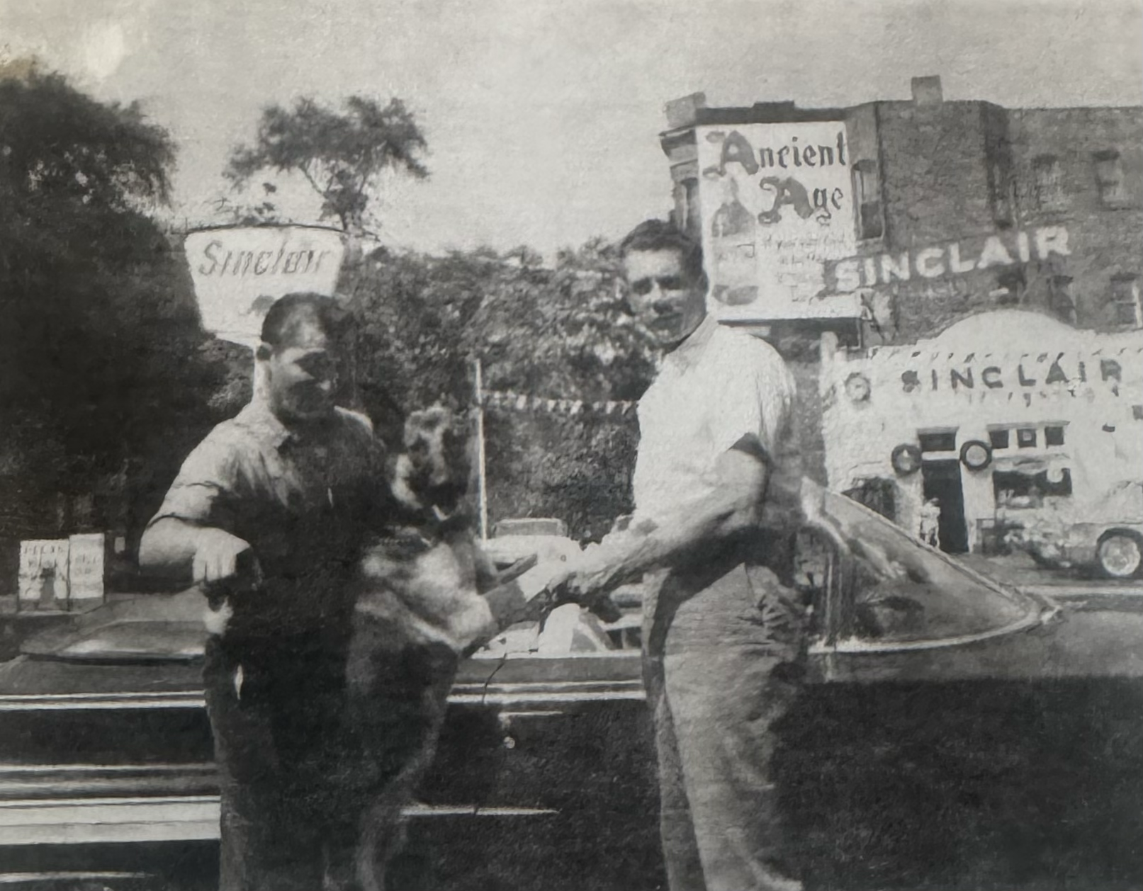 Eddy Pareti on the left and his dog, Bambino, in front of Ernie's Bleachers (now Murphy's Bleachers, in the mid-1950s. The Sinclair gas station in the foreground is now a parking lot across from Murphy's Bleachers. The man on the left in front of the