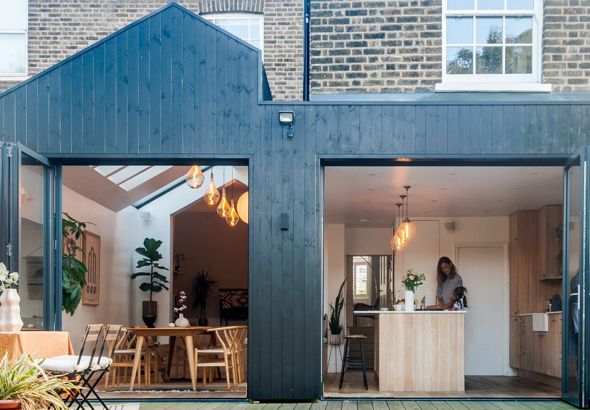 Kitchen extension design in Brockley, South East London, with open-plan kitchen dining space, garden connection and dark timber cladding.