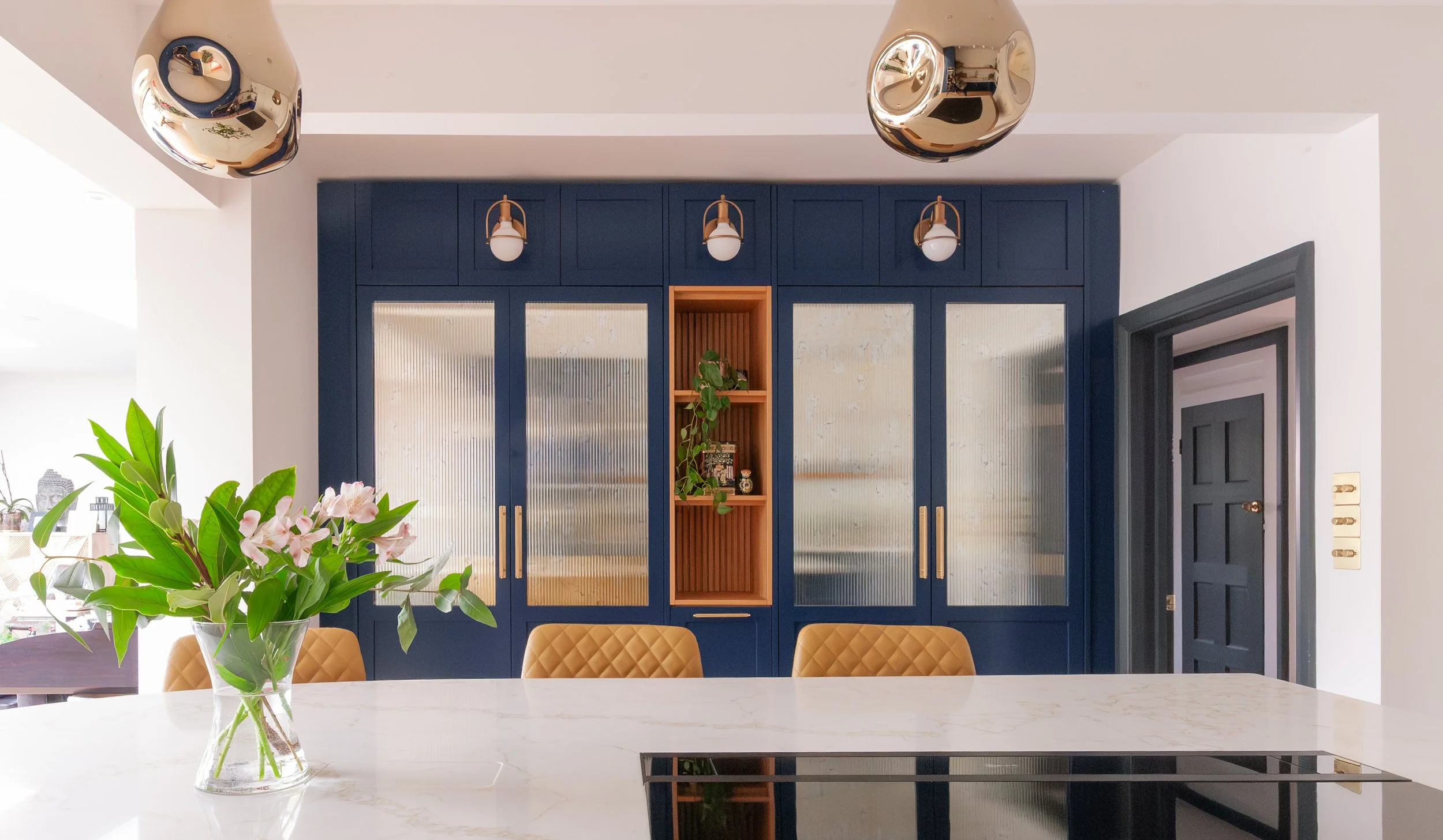 Bespoke blue glazed cabinetry and home bar wall in Beckenham kitchen with ribbed antique mirror doors