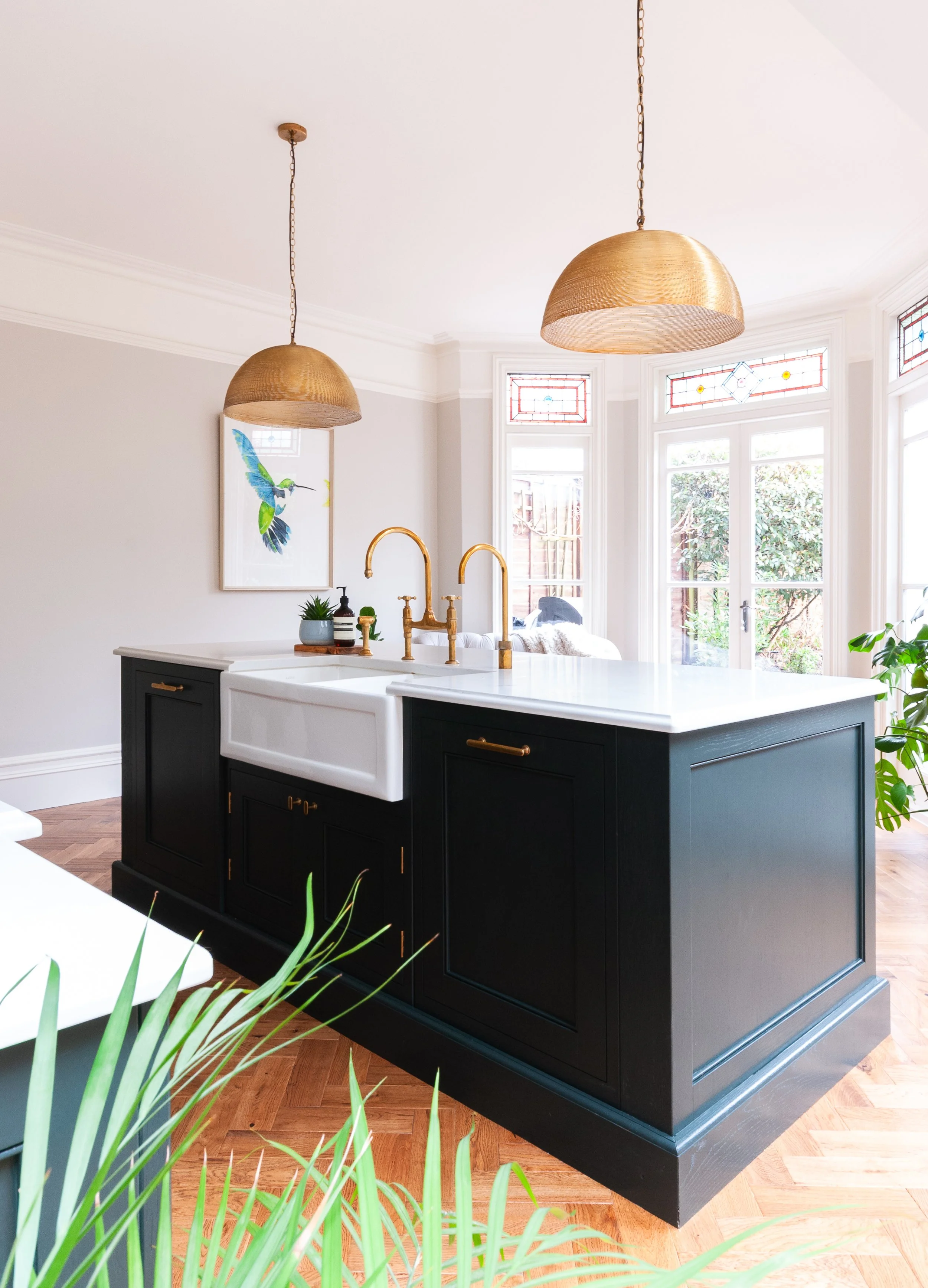 Bespoke kitchen in Herne Hill with dark island, brass tap and pendant lighting