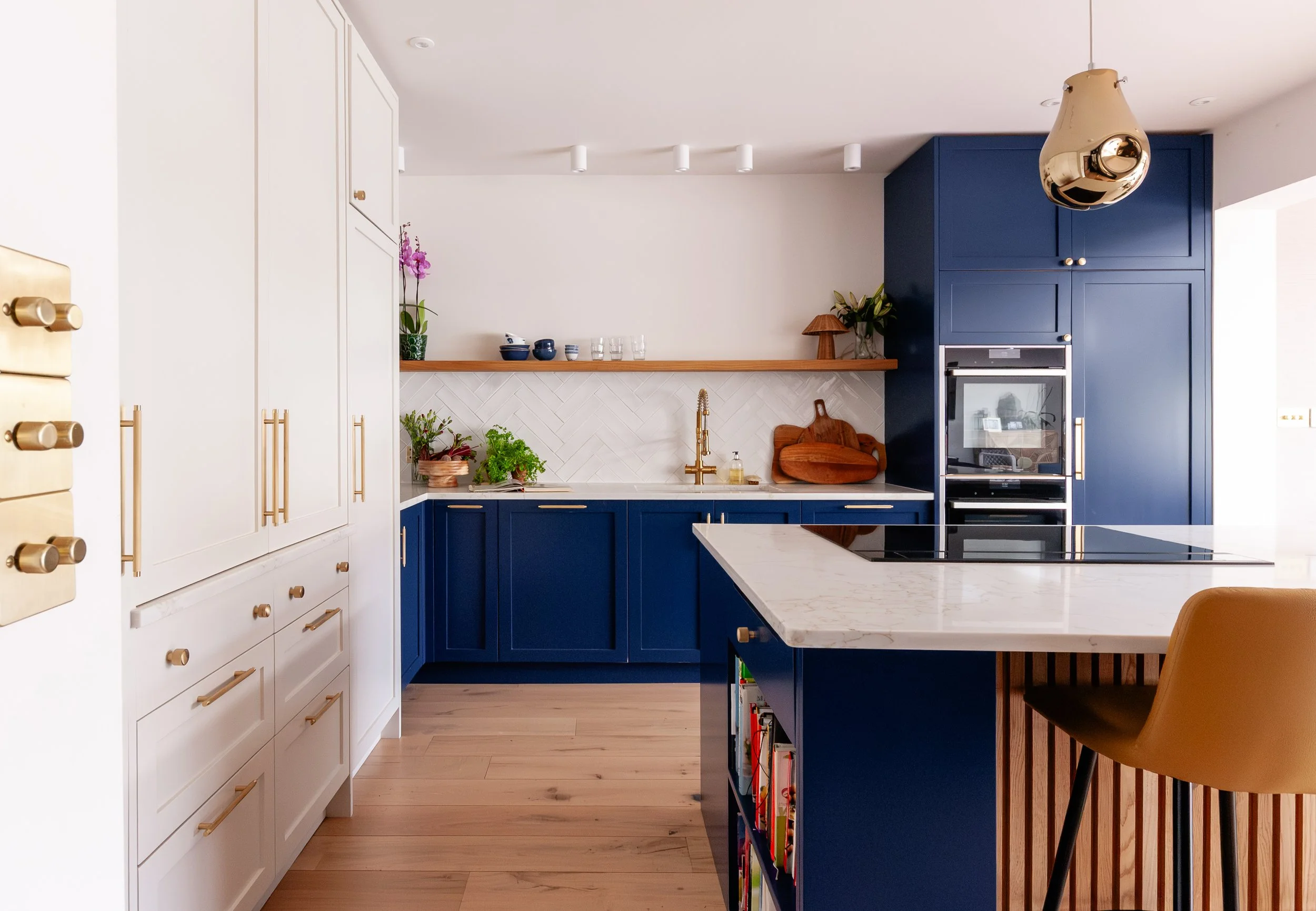 Blue kitchen island and tall cabinetry in bespoke Beckenham kitchen