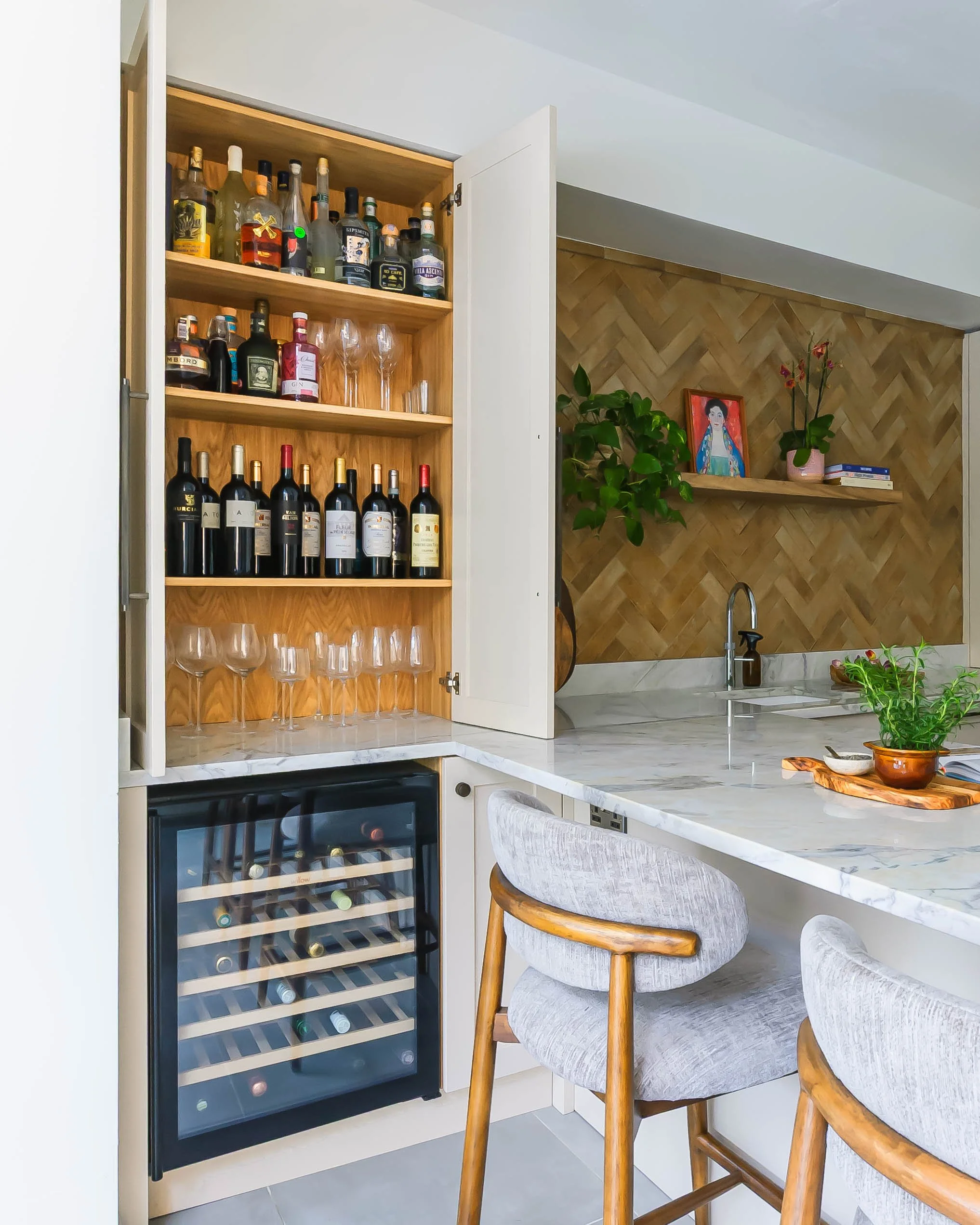 Kitchen bar storage in Forest Hill with concealed drinks cabinet, glassware, wine fridge and integrated lighting.