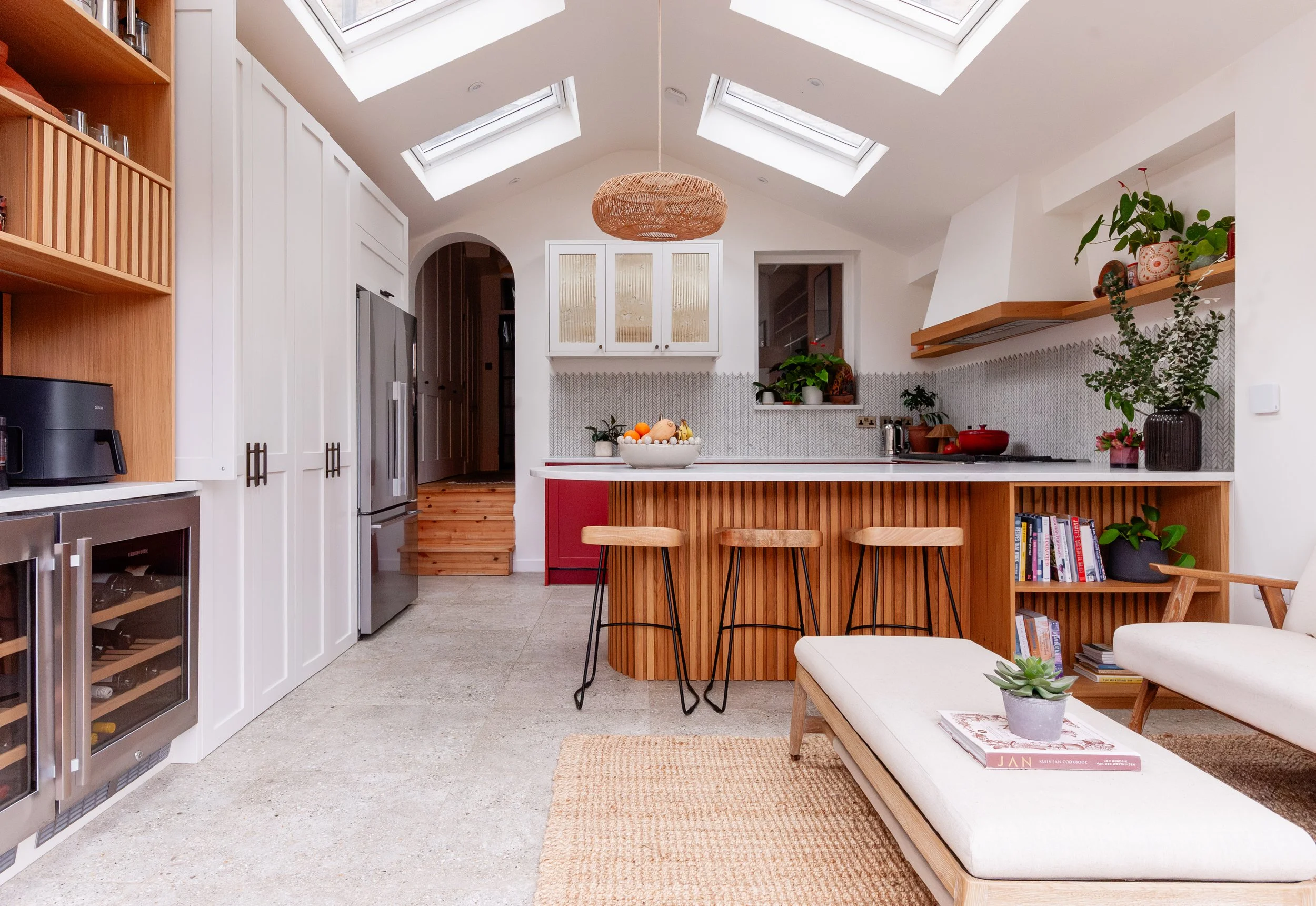 Bespoke red and oak kitchen extension in Forest Hill, South East London, with curved peninsula and garden-level layout
