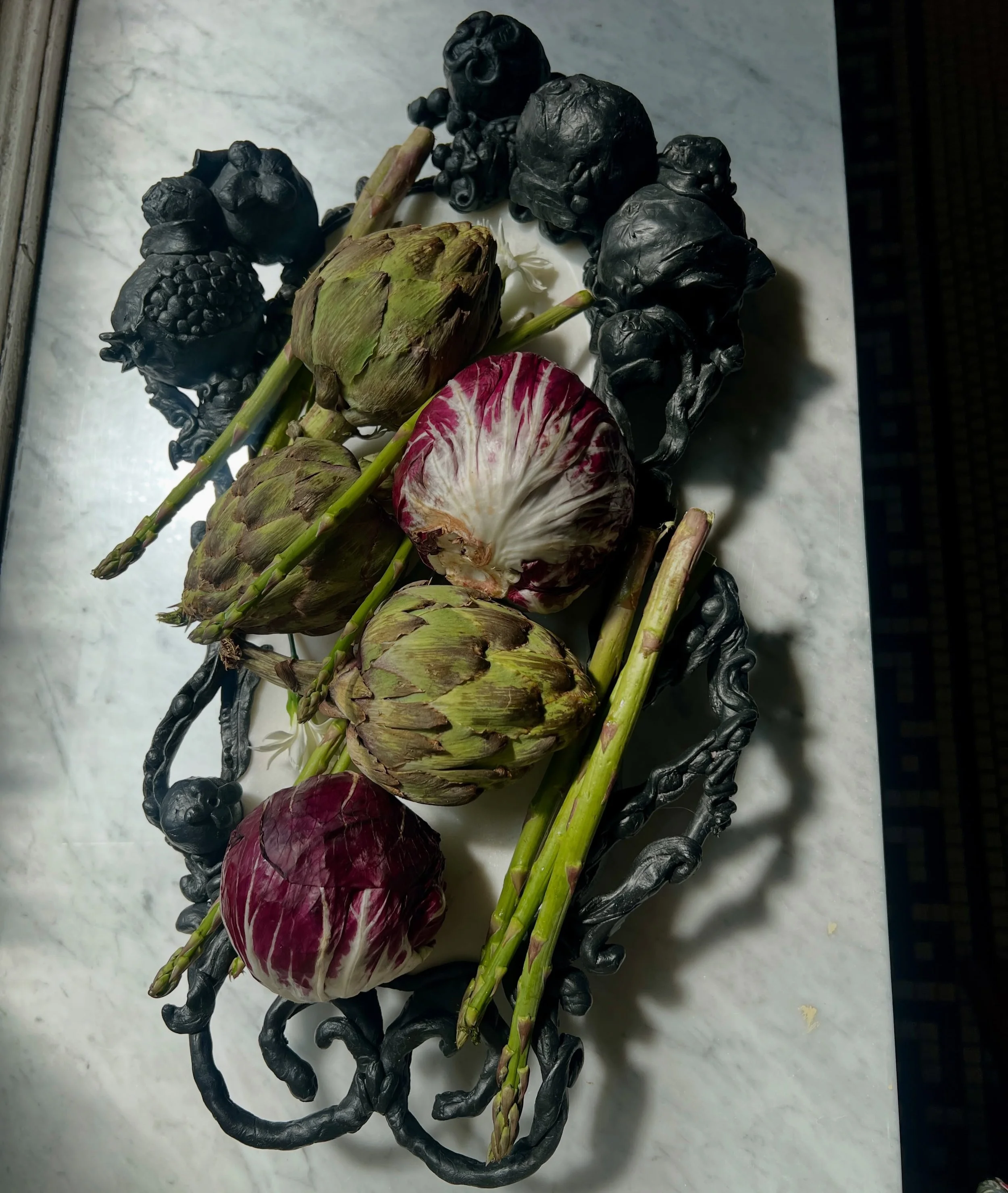 I sculpted this piece on a vintage slab of marble. Inspired by the architecture in my neighborhood Brooklyn Heights. The doorways have this sort of indistinguishable fruits hanging above them welcoming people in. 

This piece, along with my other des
