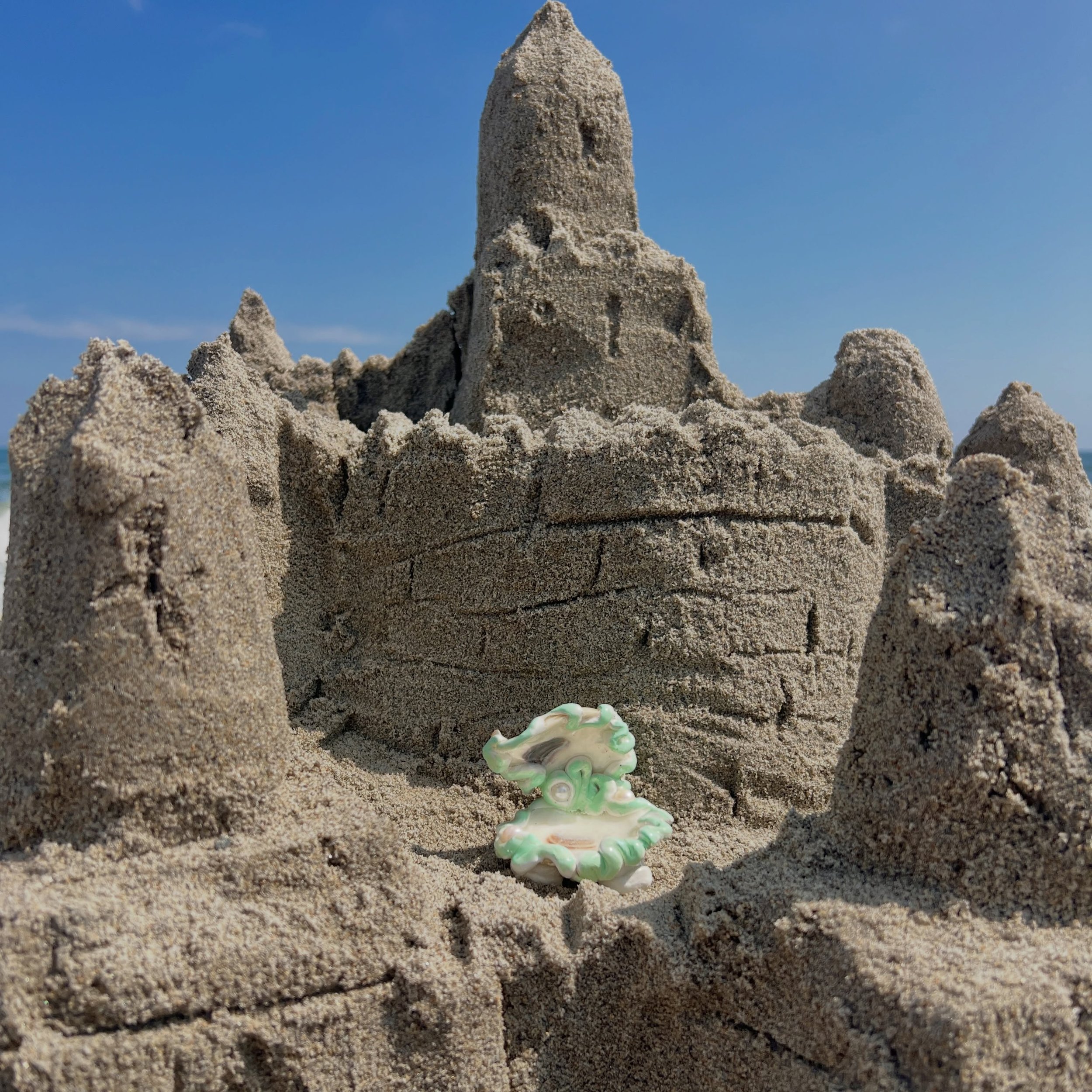 Put the males in your family to work. My dad&rsquo;s sandcastle with help from my brothers and nephew. And me in my element eating 🐟 &amp; 🍒 

My mermaid treasure ring dish made exclusively for @catbirdnyc is on vacation ooo