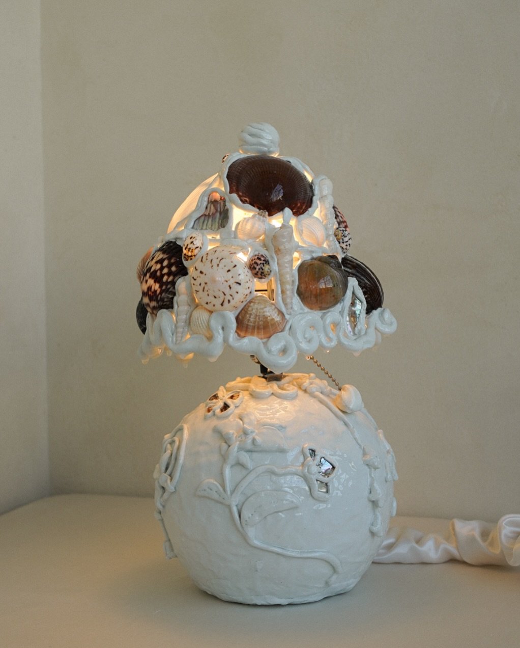A lamp for kitsch lovers, marooned sea captains, and siren mermaids haunting grottos. Available exclusively at LES Collection