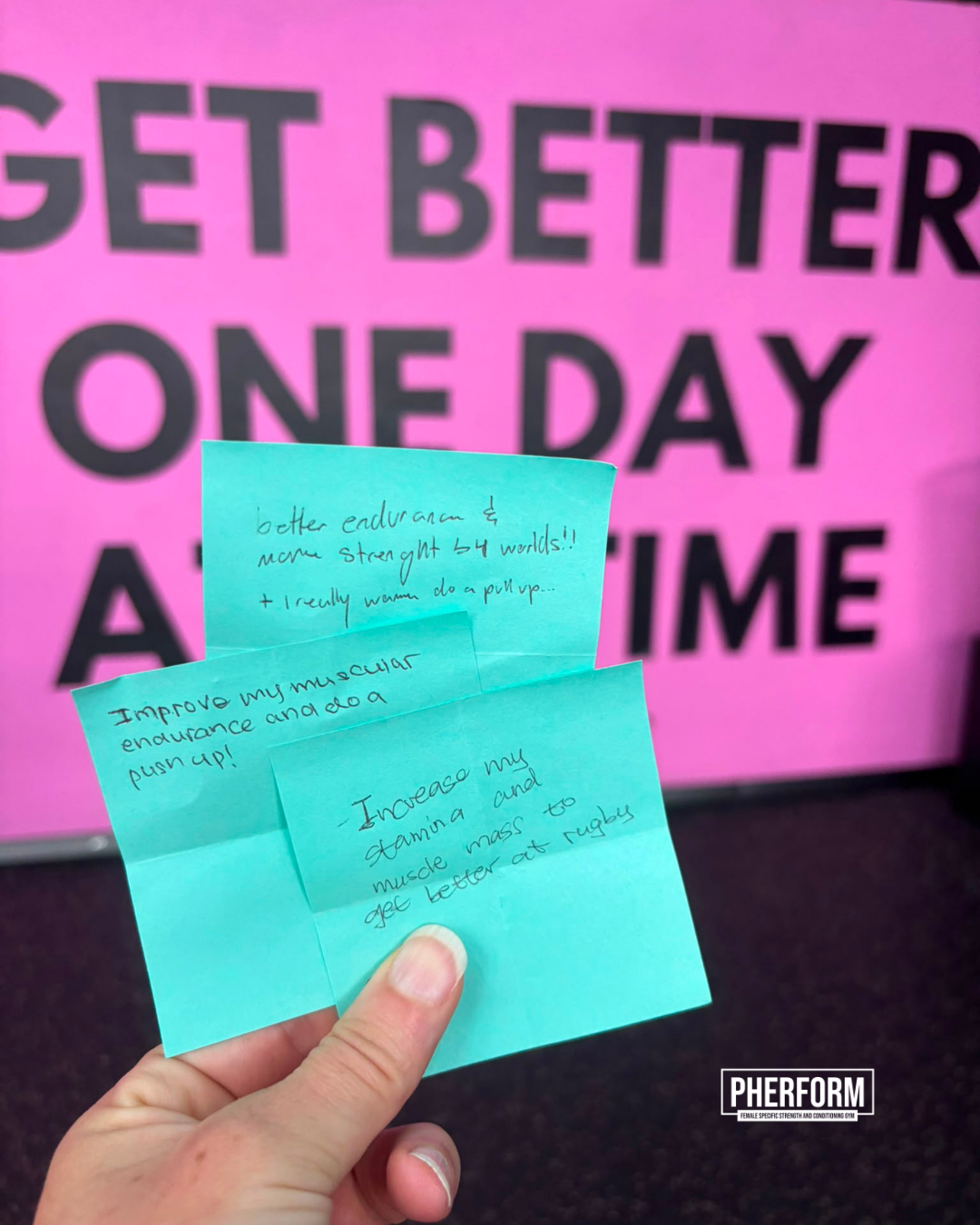 Post-it notes with teen girls' strength training goals displayed on a wall