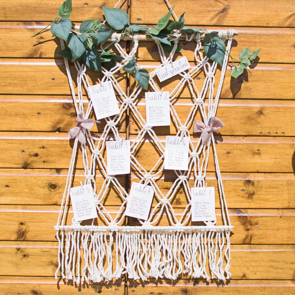 macrame-wedding-seating-plan-display-against-wood.jpg