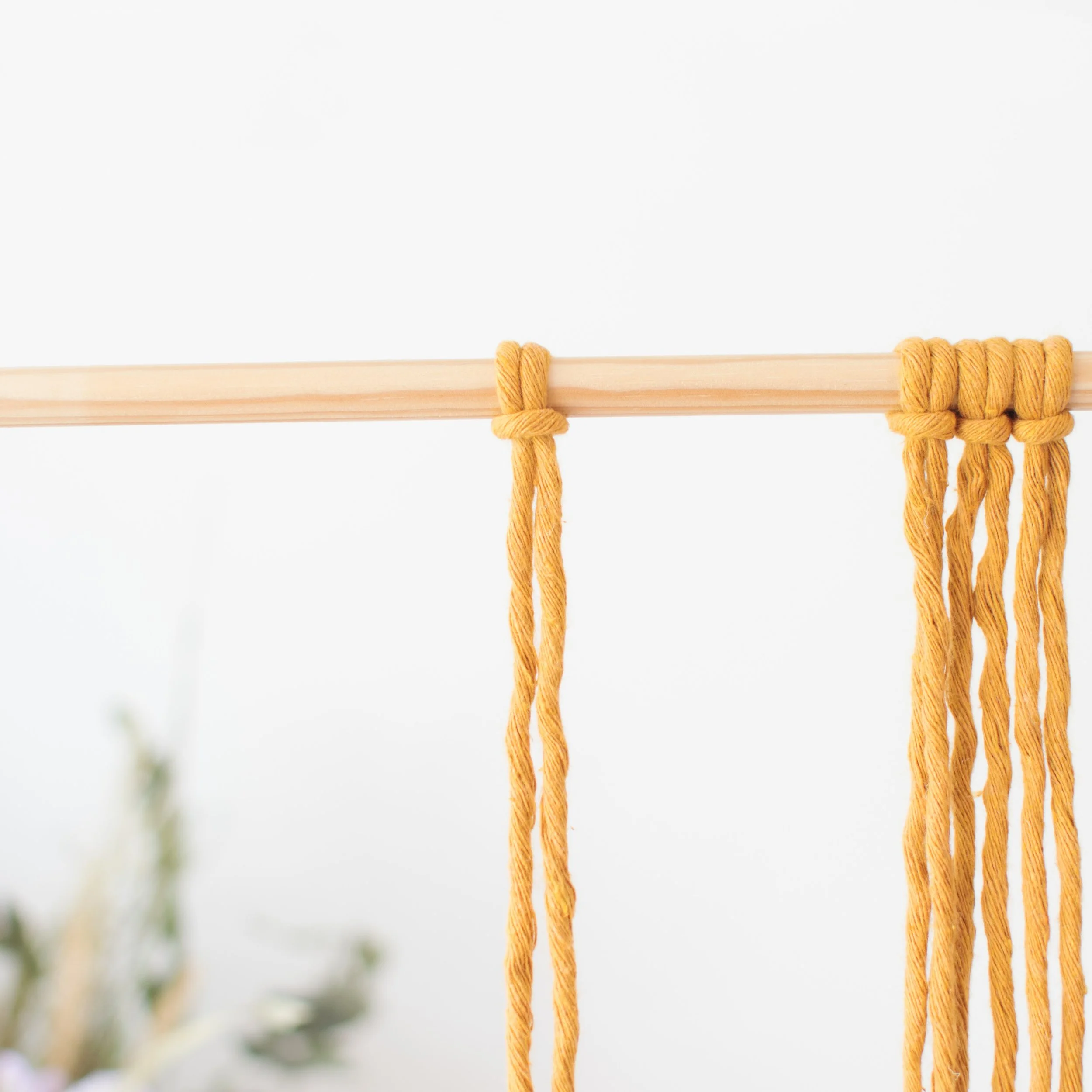 larks head knot on wooden dowel