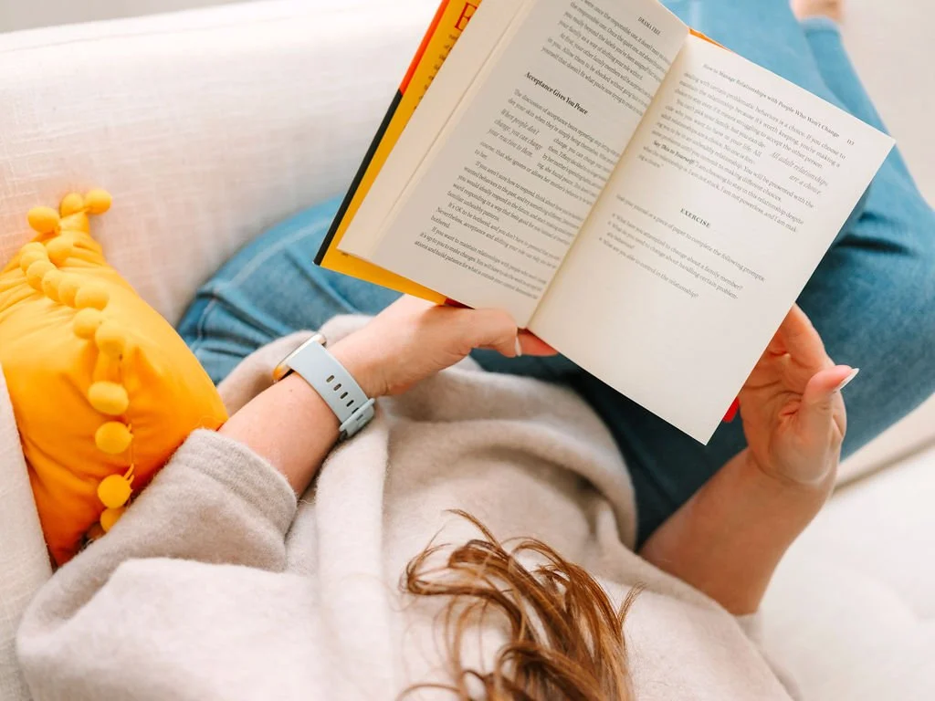 Mary Fleisch LCSW ketamine assisted emdr therapist reading a book in Oakland office