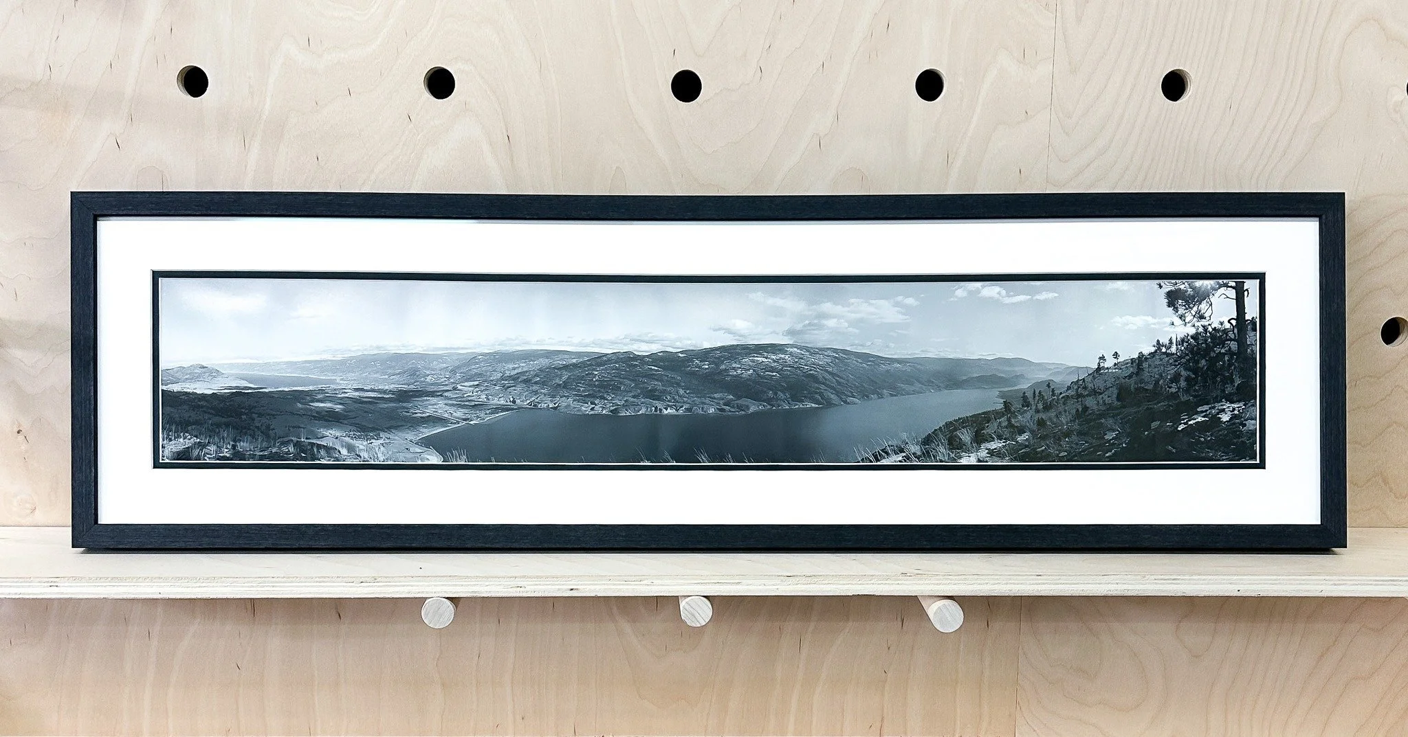 A good frame is the holiday glow-up your walls didn&rsquo;t know they needed. ✨🎁 Panorama photograph of Skaha Lake, Penticton by the late Photographer Hugo Redivo.
 #penticton #panorama #photography📷 #skahalake #framedfriday #art🎨 #bravoarts #loca