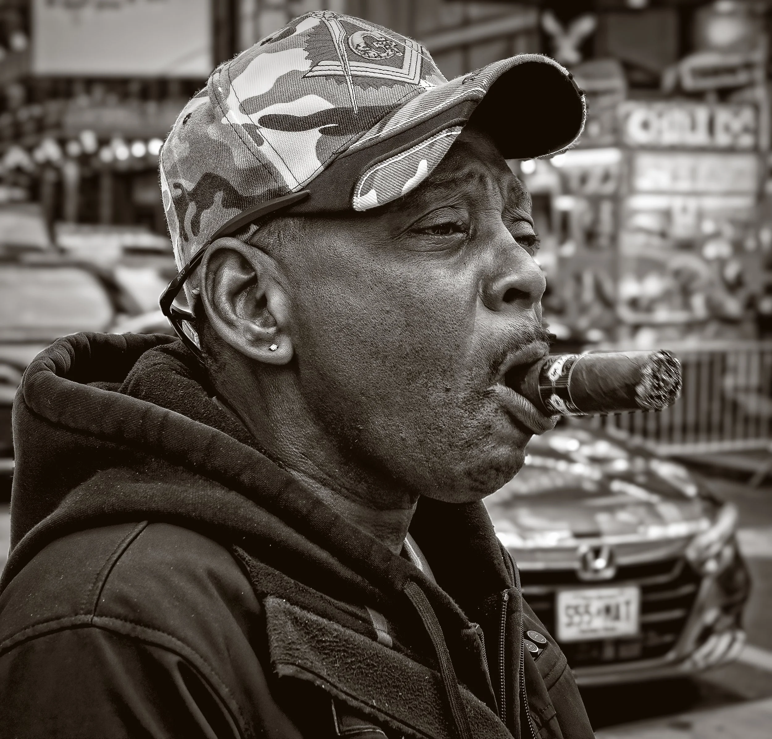 The only non-candid shot.  I noticed this guy smoking this HUGE cigar.  I asked him if he would mind me taking his photograph.  He smiled and proudly puffed away