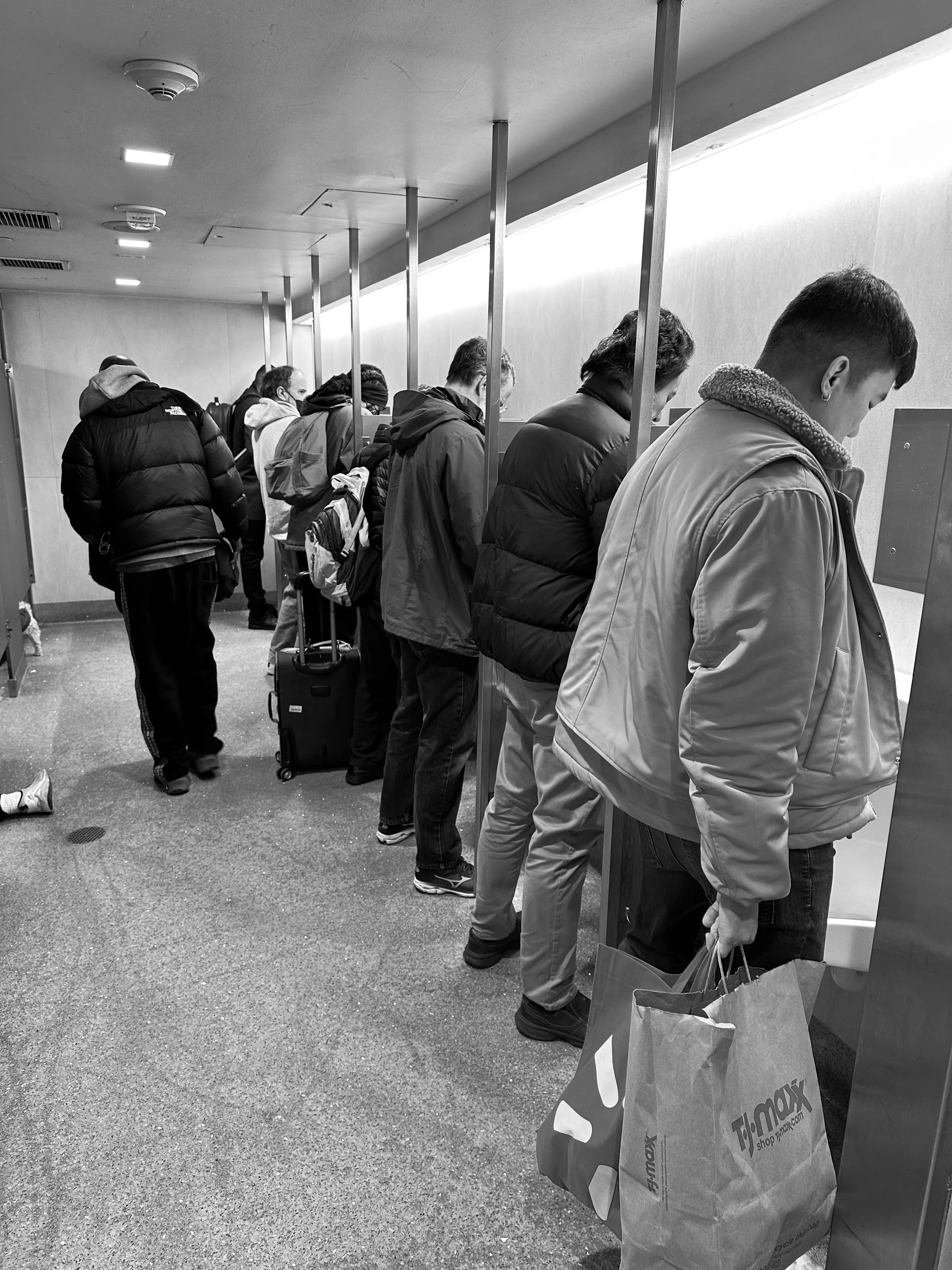 While waiting in line in the men's room at Penn Station I noticed this foot under a stall door.  I wondered...is he sleeping?  Is he injured?  Is he even alive?  