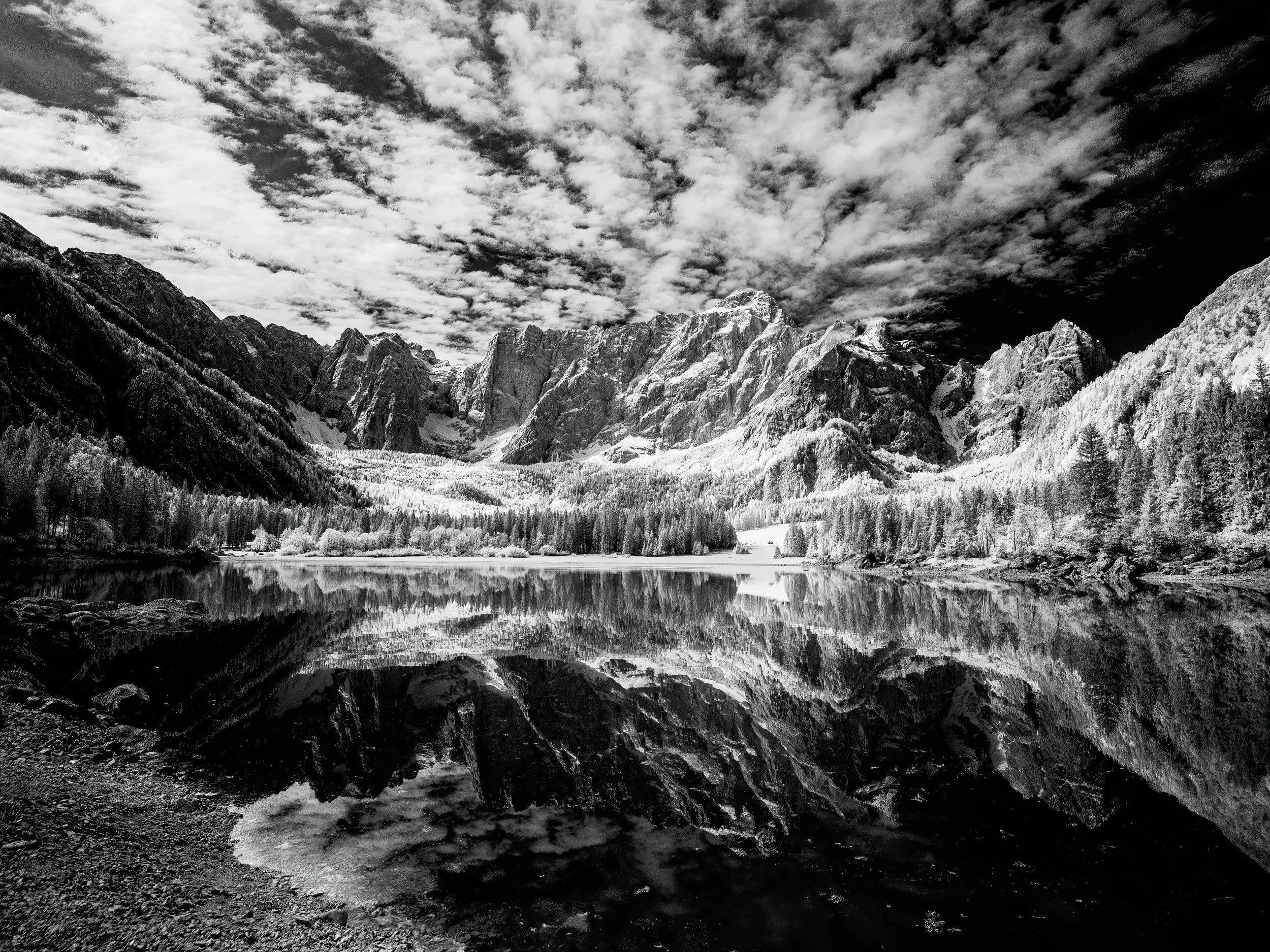 The reflection of the mountains almost blocks the lake