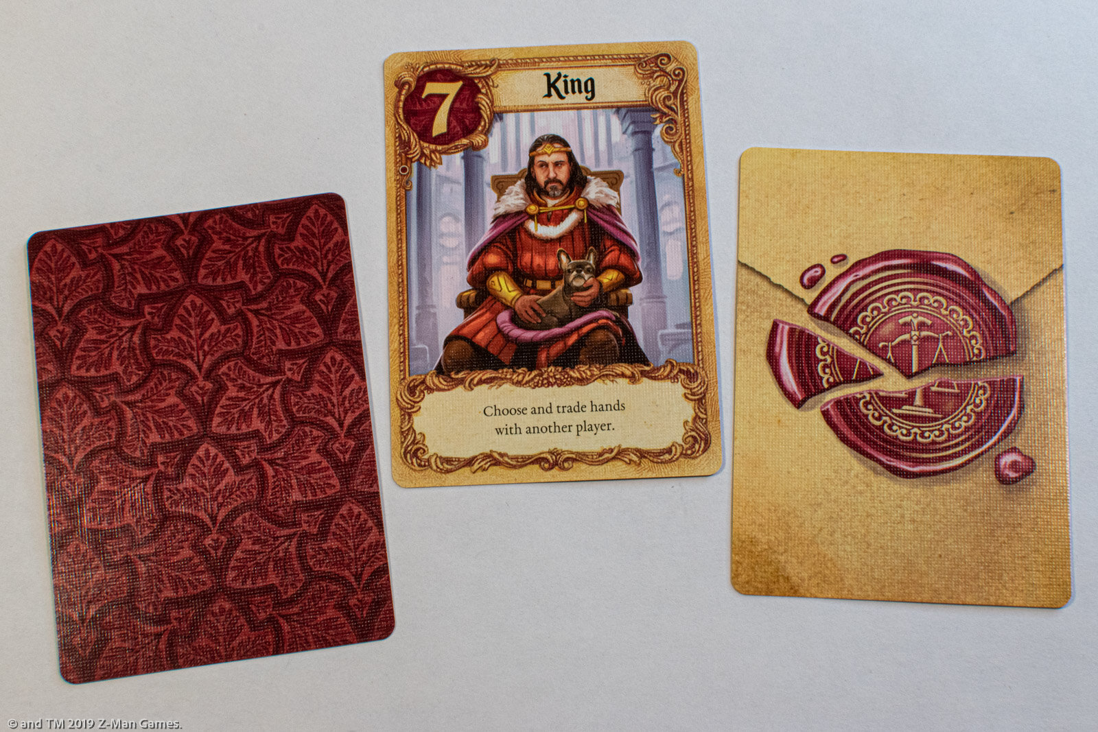 Love Letter (Z-Man Edition) cards. Poker size. Left: game card back, center: game card fronts, right: reference card back.