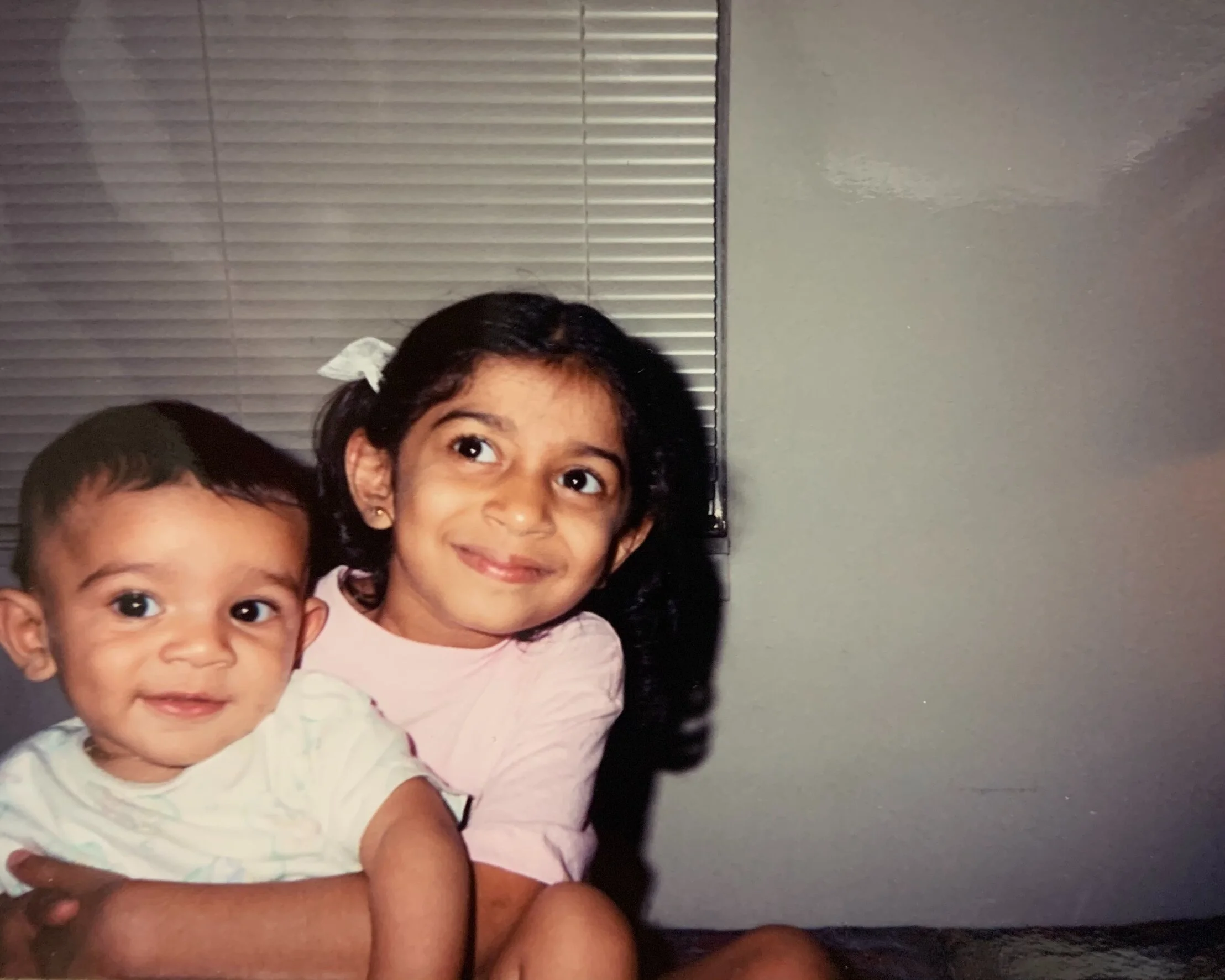 Ashmi and her younger brother as children