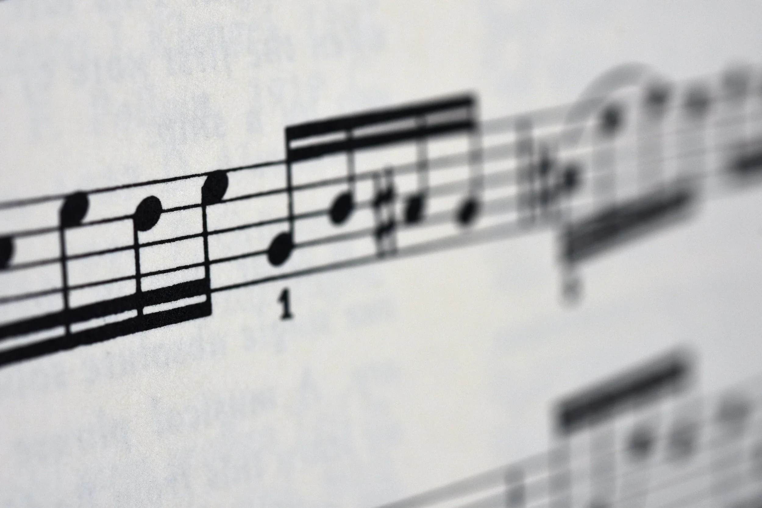 Close-up of sheet music with musical notes on a staff.