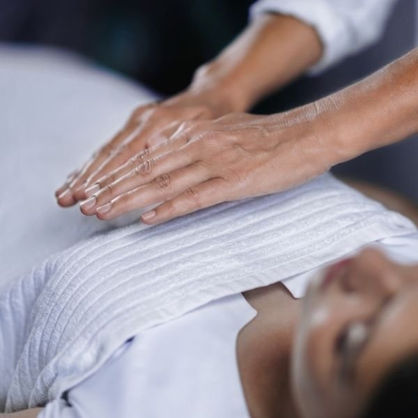 Practitioner providing an in-person Ensofic Reiki healing session